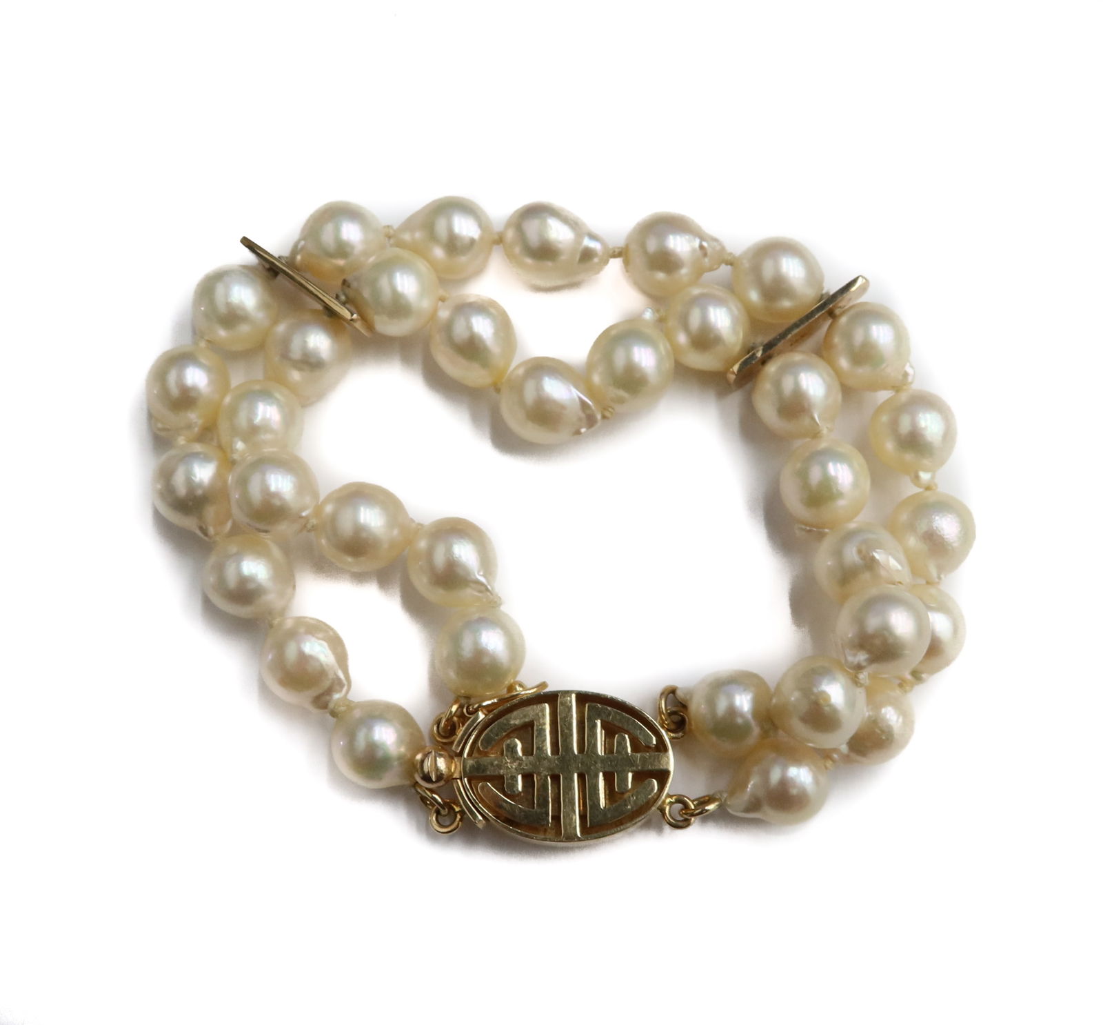 Gump's 14k Yellow Gold and Freshwater Cultured Pearl Double Strand Bracelet: Gump's 14k Yellow Gold and Freshwater Cultured Pearl Double Strand Bracelet. Pearls measures 6.9mm. Clasp marked Gump's 14k. Weight Approx., 30.29 grams Measures Approx., 7 inches Domestic Shipping:$2