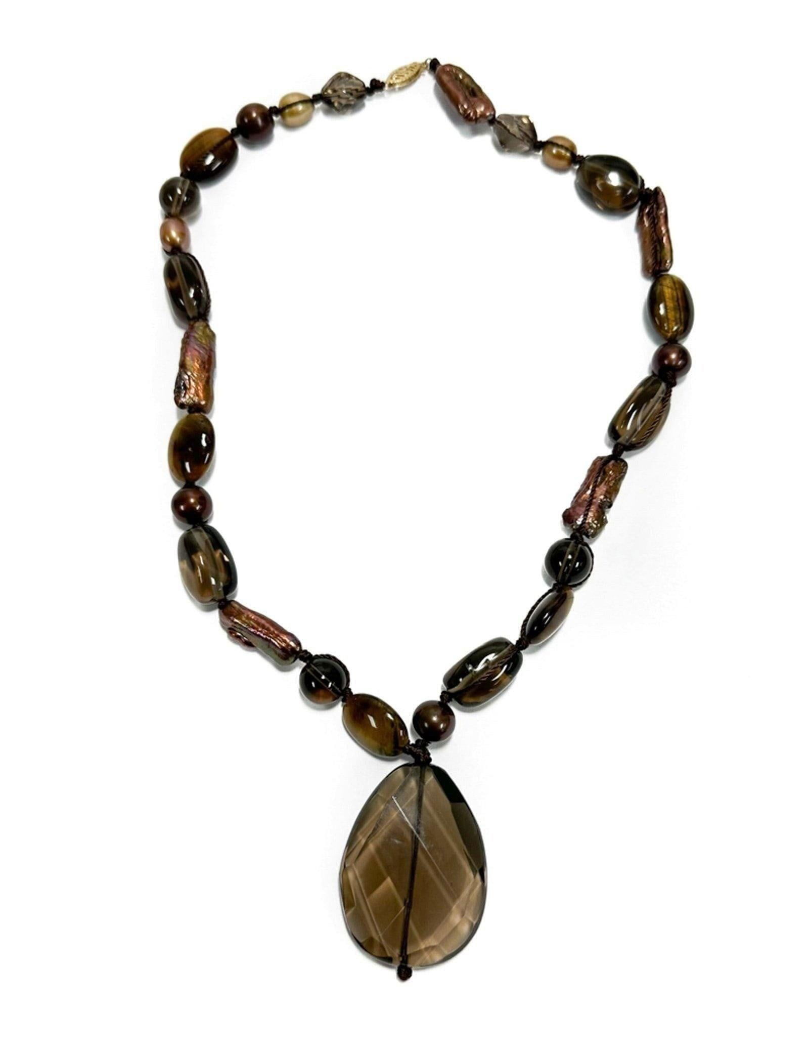 14k Yellow Gold Smokey Quartz and Natural Purple Pearl Necklace: 14k Yellow Gold Smokey Quartz and Purple Pearl Necklace. Large smoky quartz centered drop bead. The strand with tumbled and faceted smoky quartz purple pearls. Marked "585" to gold clasp. Weight Appro