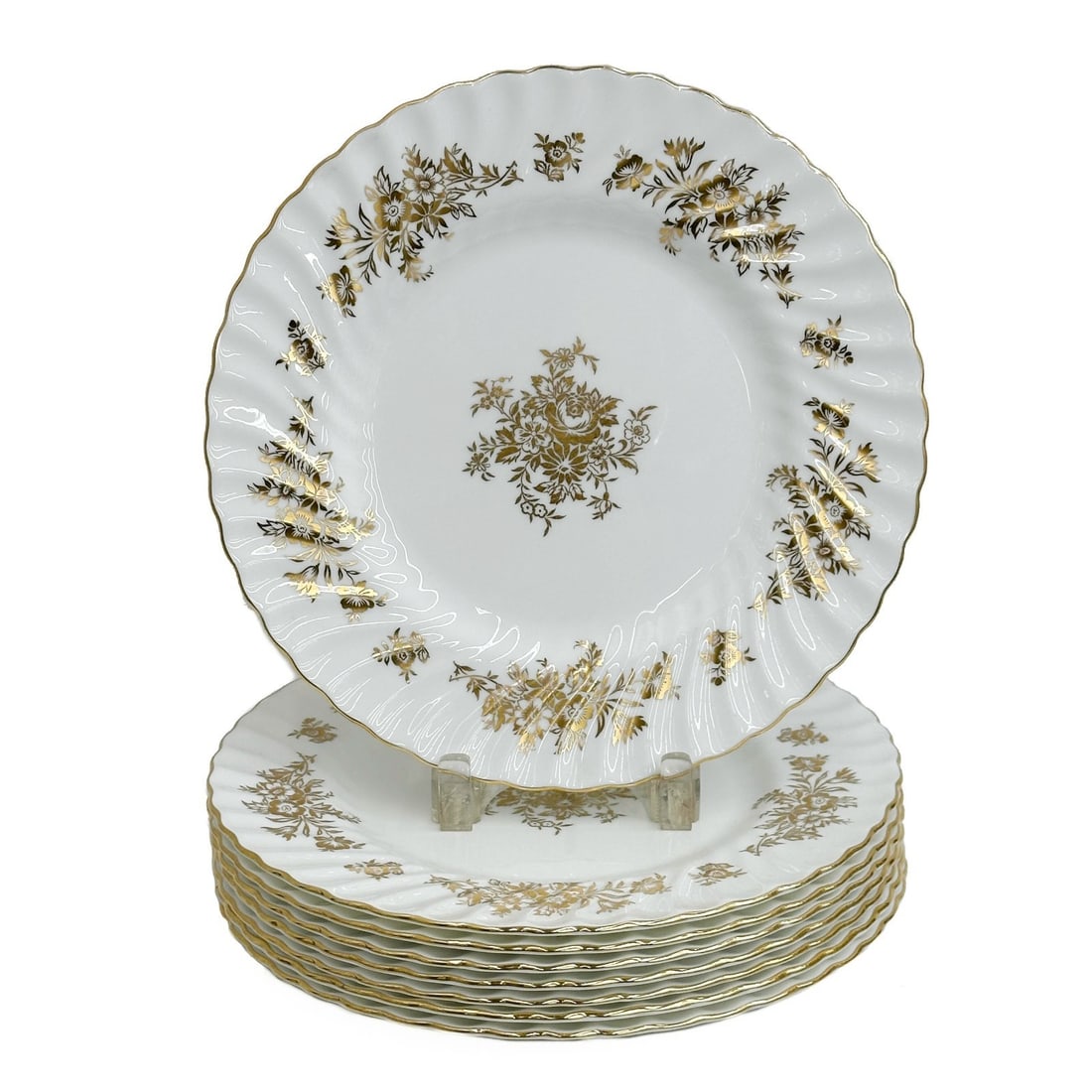 8 Minton England Gilt Porcelain Dinner Plates H5017 circa 1957: 8 Minton England Gilt Porcelain Dinner Plates in H5017. A white ground decorated with gilt florals, scalloped textured edge. Underside with gold Minton marks, date code for 1957, one marked for 1956 W