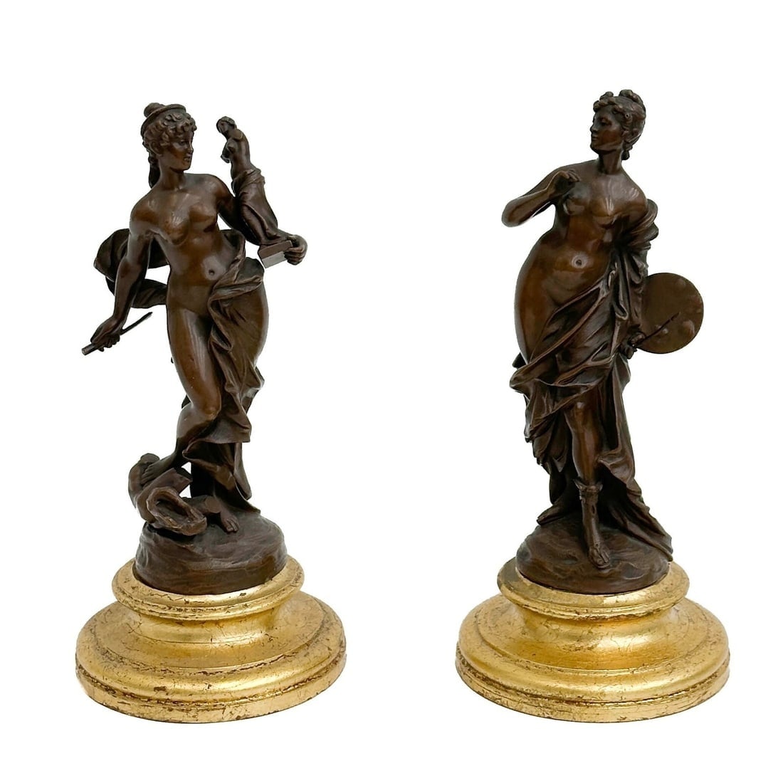 Pair Continental Bronze Figurines Women the Arts 19th century: Pair Continental Bronze Figurines, 19th century. Depicts a pair of nude women holding the arts, sculpture and painting. Gilt circular wood bases. Weight: Approx. 7 lbs Measurements: Approx. 4.125
