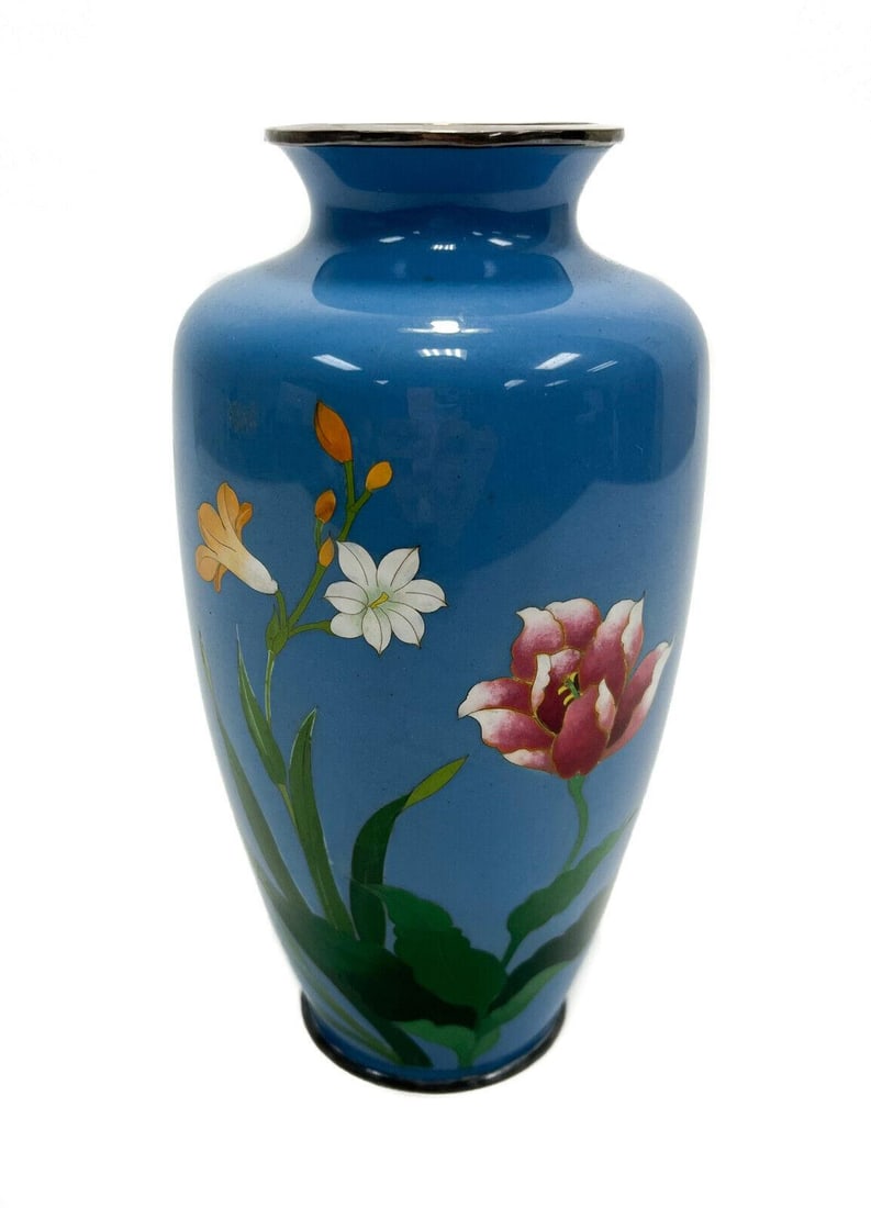 Japanese Cloisonne Enamel Florals Teal Blue Vase Silverplate Mounts: Japanese cloisonne enamel vase with silver plate mounts, Mid 20th Century. A teal blue ground with an orange, white and red flower to the central area. silver plate mounts to the top and base rim. Wei