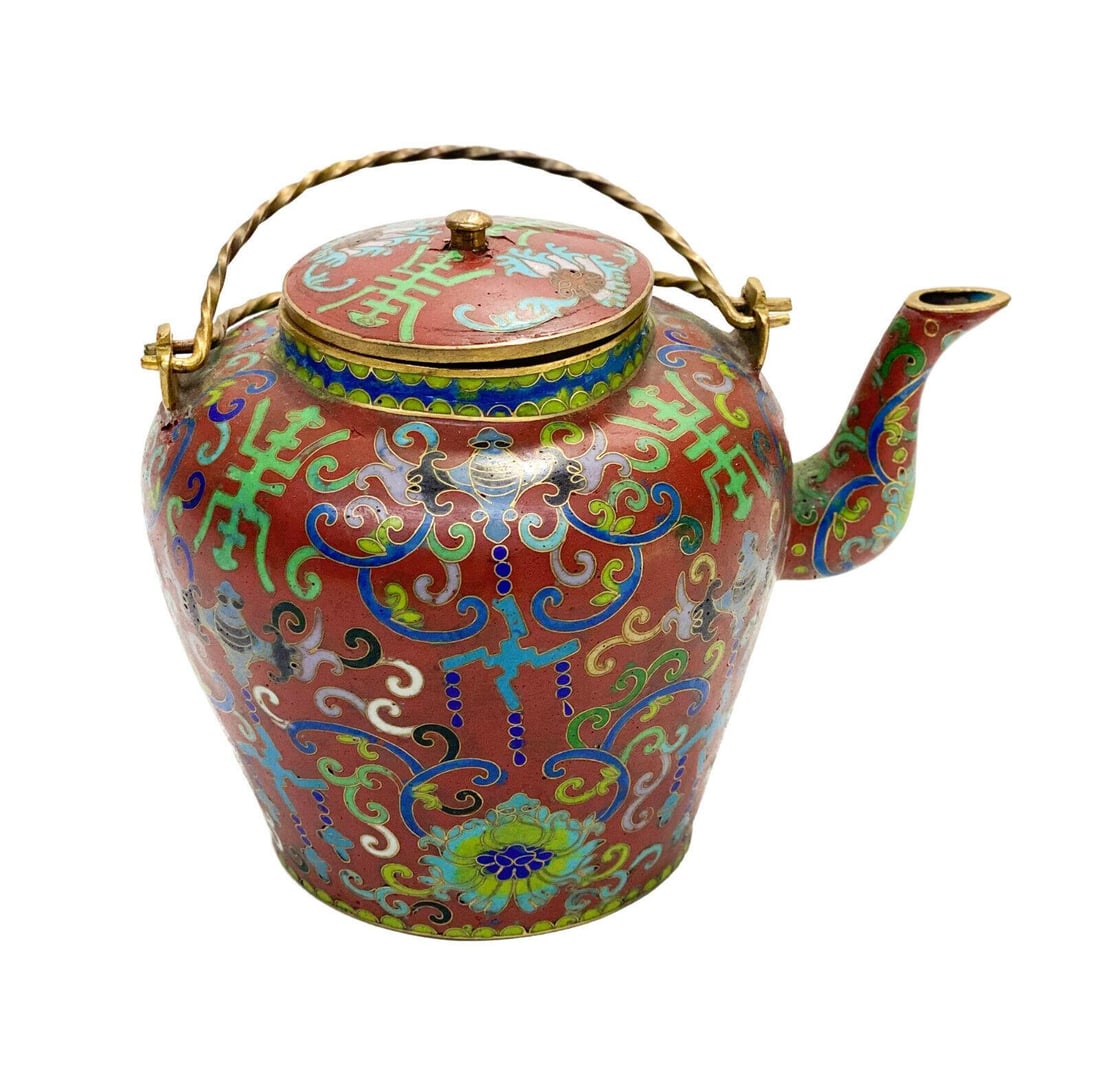 Chinese Cloisonne Enamel and Gilt Metal Teapot. Florals and Swirls: Chinese cloisonne enamel and gilt metal teapot. A maroon red ground with blue and green enamel florals and swirls throughout. Gilt to the handle. Weight: Approx. 0.9 lbs Measurements: Approx. 7 inches