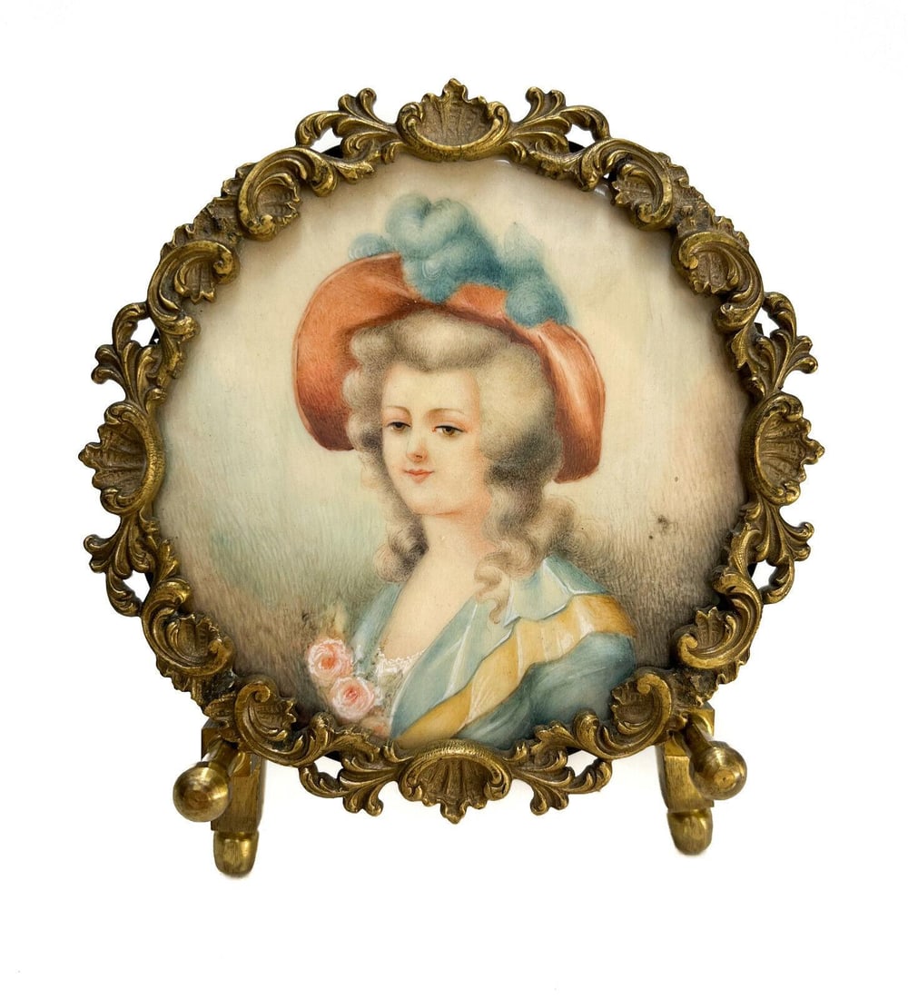 Continental Miniature Hand Painted Watercolor Gouache Portrait of Beauty, c1900: Continental miniature hand painted watercolor gouache portrait of beauty, circa 1900. The portrait depicts a beauty in light blue and gold garbs and a large red hat with blue feathers. There is a poss