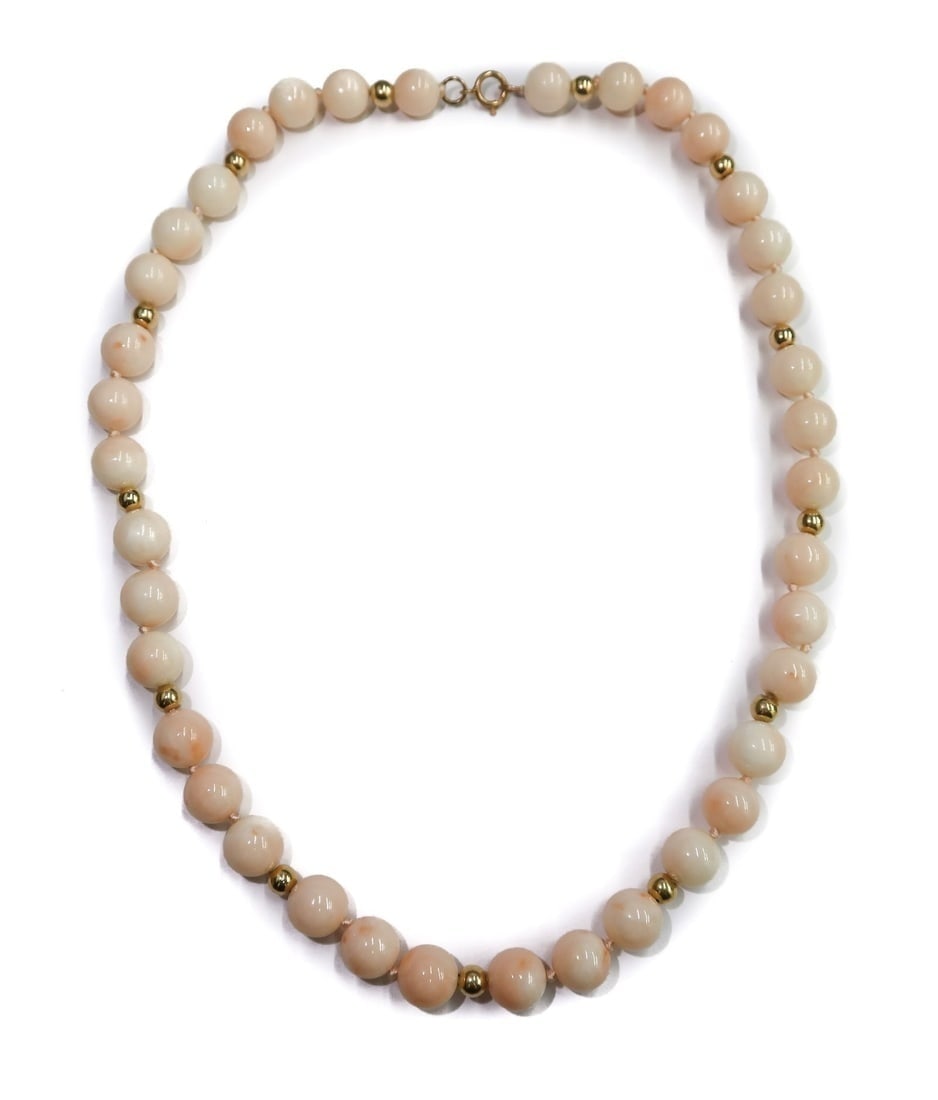 14k Yellow Gold and Pink Coral Single Strand Necklace: 14k Yellow Gold and Pink Angel Skin Coral Single Strand Necklace. 38 coral beads measuring 9mm with round gold spacers. Marked 14k to clasp. Weight Approx., 41.62 Domestic Shipping: $25