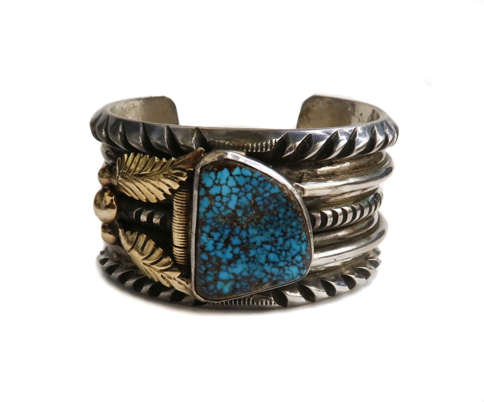 Southwest Silver and Yellow Gold Turquoise Cuff Bracelet: Southwest Silver and Yellow Gold Turquoise Cuff Bracelet. Multi ridged cuff with an applied Turquoise center in etched gold leaf accents. Cuff tests for silver and the gold tests for at least 14k. Wei