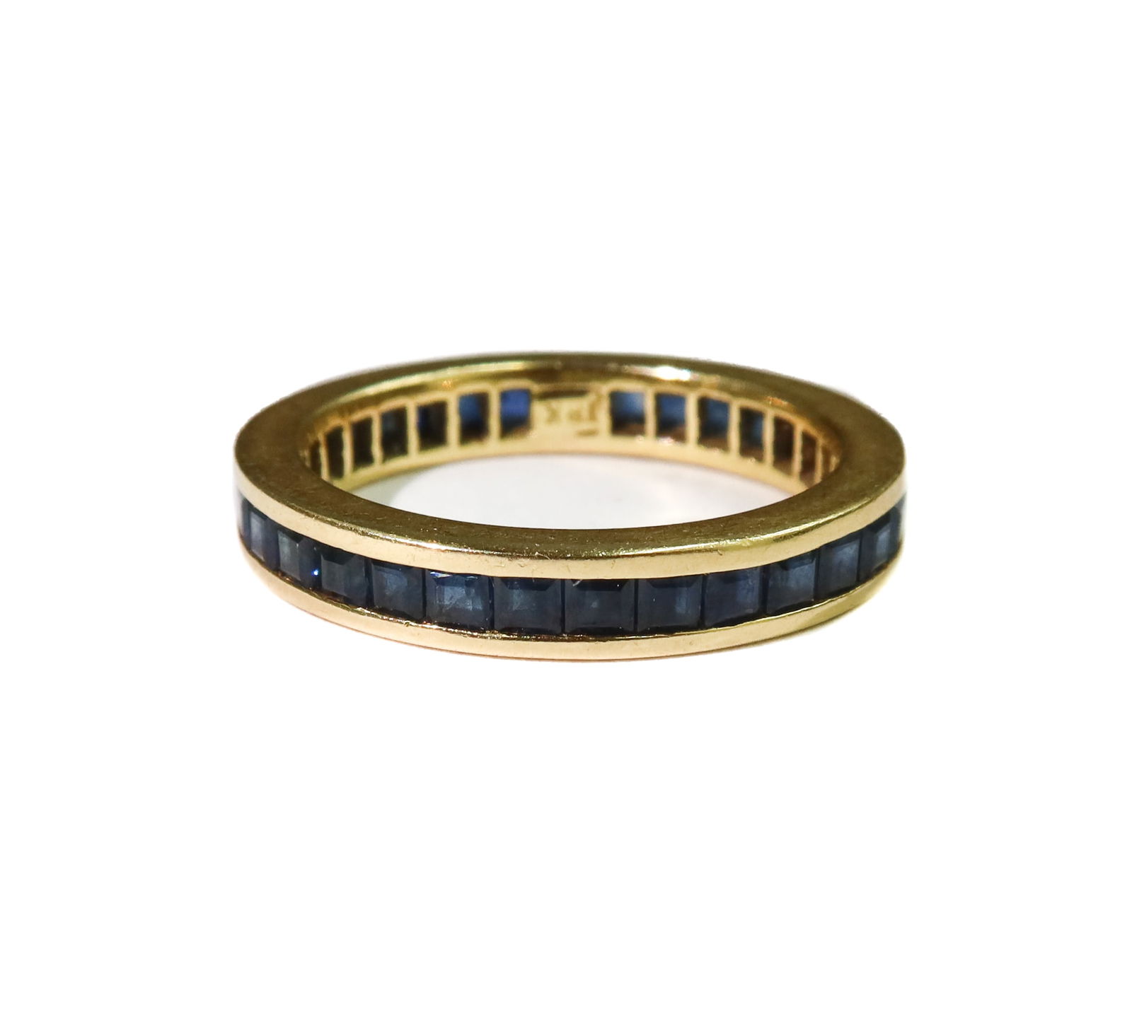 18k Yellow Gold and Blue Sapphire Eternity Ring Size 6: 18k Yellow Gold and Blue Sapphire Eternity Ring Size 6. Around 34 square cut sapphires to band weighing approximately 1.4 carats. Marked 18k. Weight Approx., 3.76 grams Measures Approx., Size 6 Domest