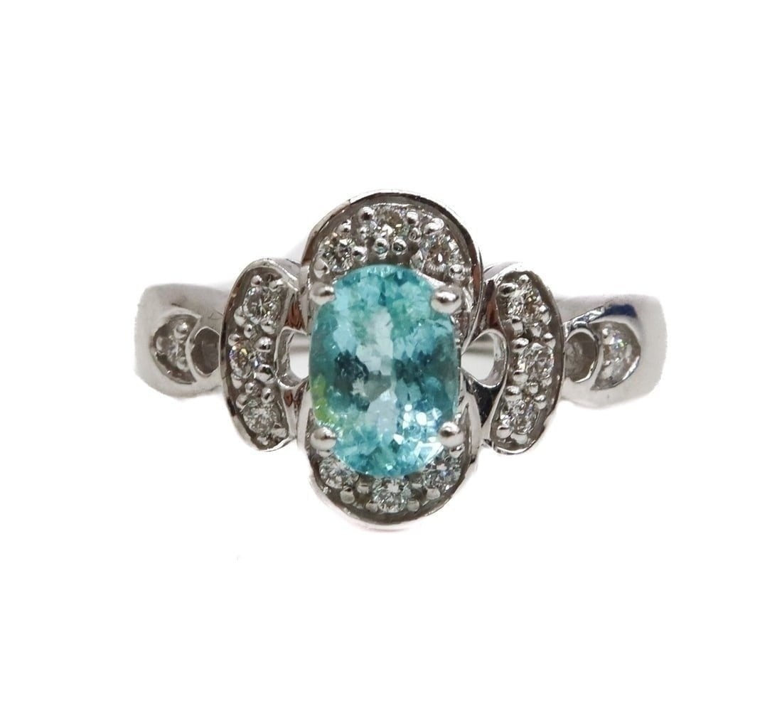 18k White Gold Aquamarine and Diamond Ring, Size 7: 18k White Gold Aquamarine and Diamond Ring, Size 7. Oval cut aquamarine center with diamonds to the petaled frame. Marked 18k to inner band. Weight Approx., 5.83 grams / Aquamarine: 0.67 carats / Diam