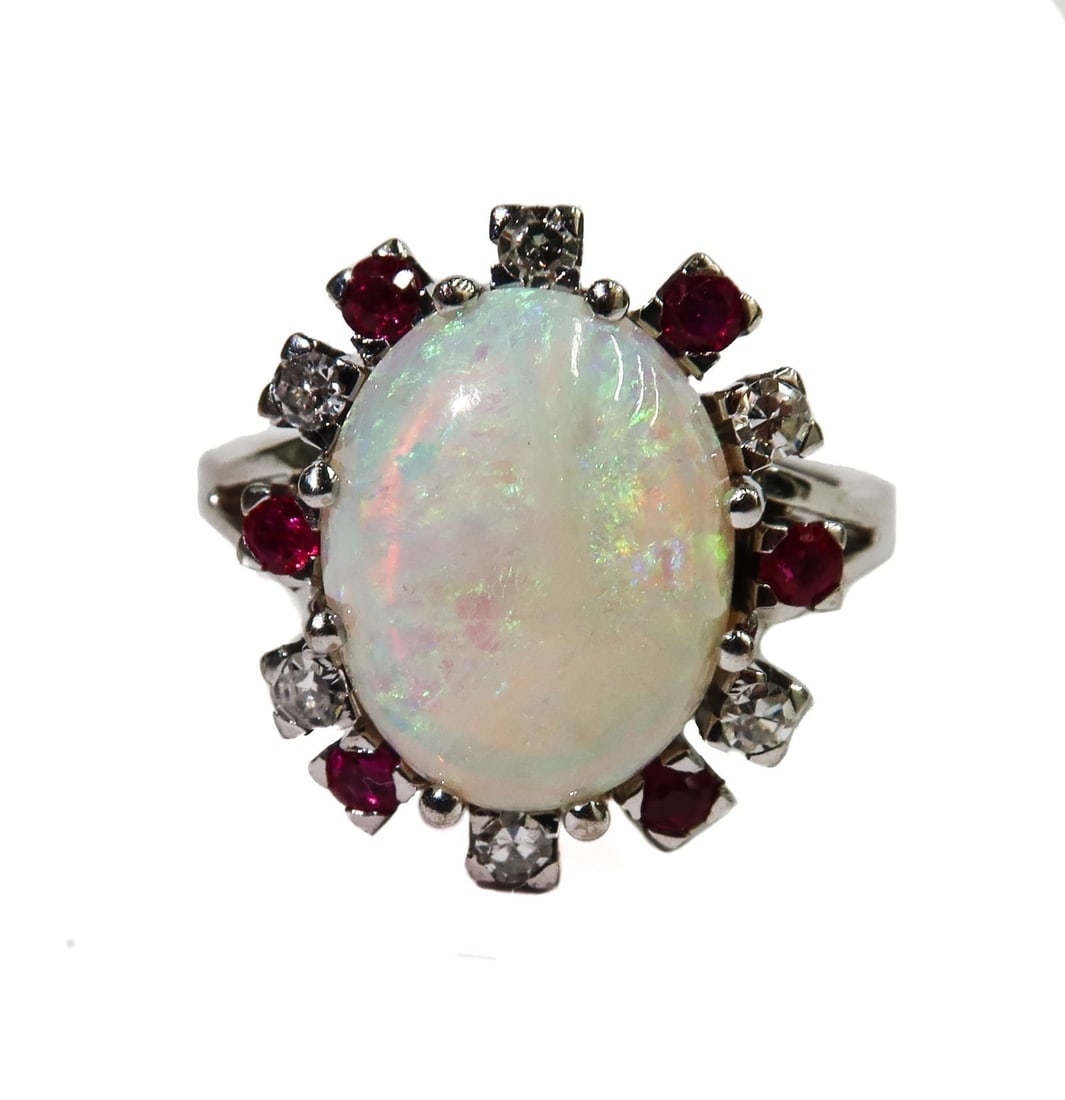 14k Yellow Gold Opal Ruby and Diamond Ring Size 7.75: 14k Yellow Gold Opal Ruby and Diamond Ring Size 7.75. Oval cut opal center measuring approximately 13.9mm x 10.6mm x 6.3mm with round cut rubies that weigh 0.3 carats and diamonds to frame that weigh