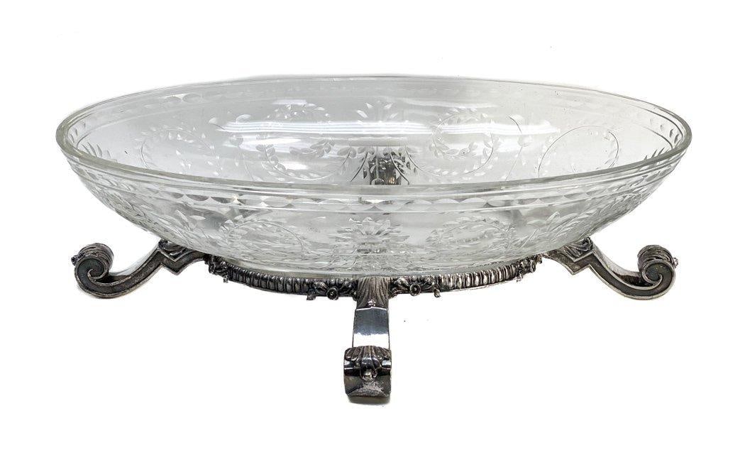Cut Glass Centerpiece Bowl with Silverplate Stand, circa 1900: Cut glass centerpiece bowl silverplate stand, circa 1900. Etched laurel leaves and florals to the exterior. Scrolled to the silverplate feet. Unknown maker mark hallmark to one of the feet- Likely Eng