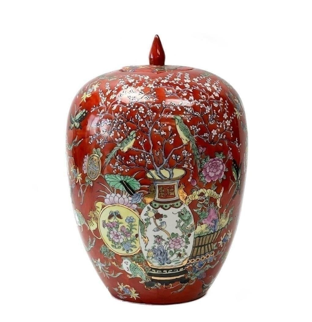20th century Chinese Hand Painted Porcelain Red Lidded Jar Insects Florals: Chinese hand painted porcelain lidded jar, 20th century. A red ground with colorful images of vases, cherry blossoms, birds, and insects. Gilt accents. Underside with Chinese maker's mark. Weight Appr