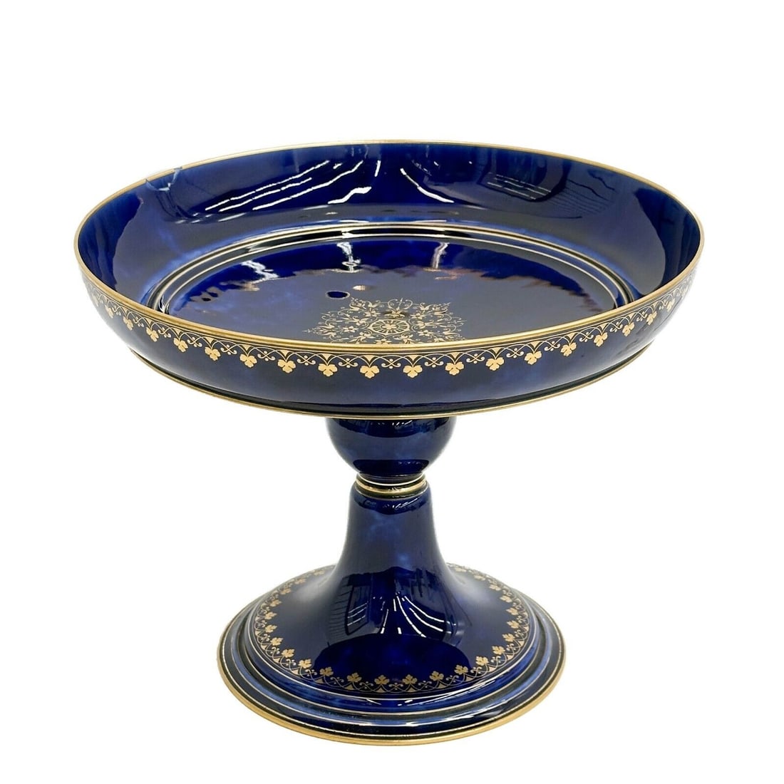 Sevres Cobalt Blue Gilt Porcelain Compote Tazza 1887: Sevres Cobalt Blue Porcelain Compote Tazza, 1887. A mottled cobalt blue ground, gilt floral accents. Underside marked Dore a Sevres 87, S84 Weight: Approx. 3 lbs Measurements: Approx. 10.5 inches diam