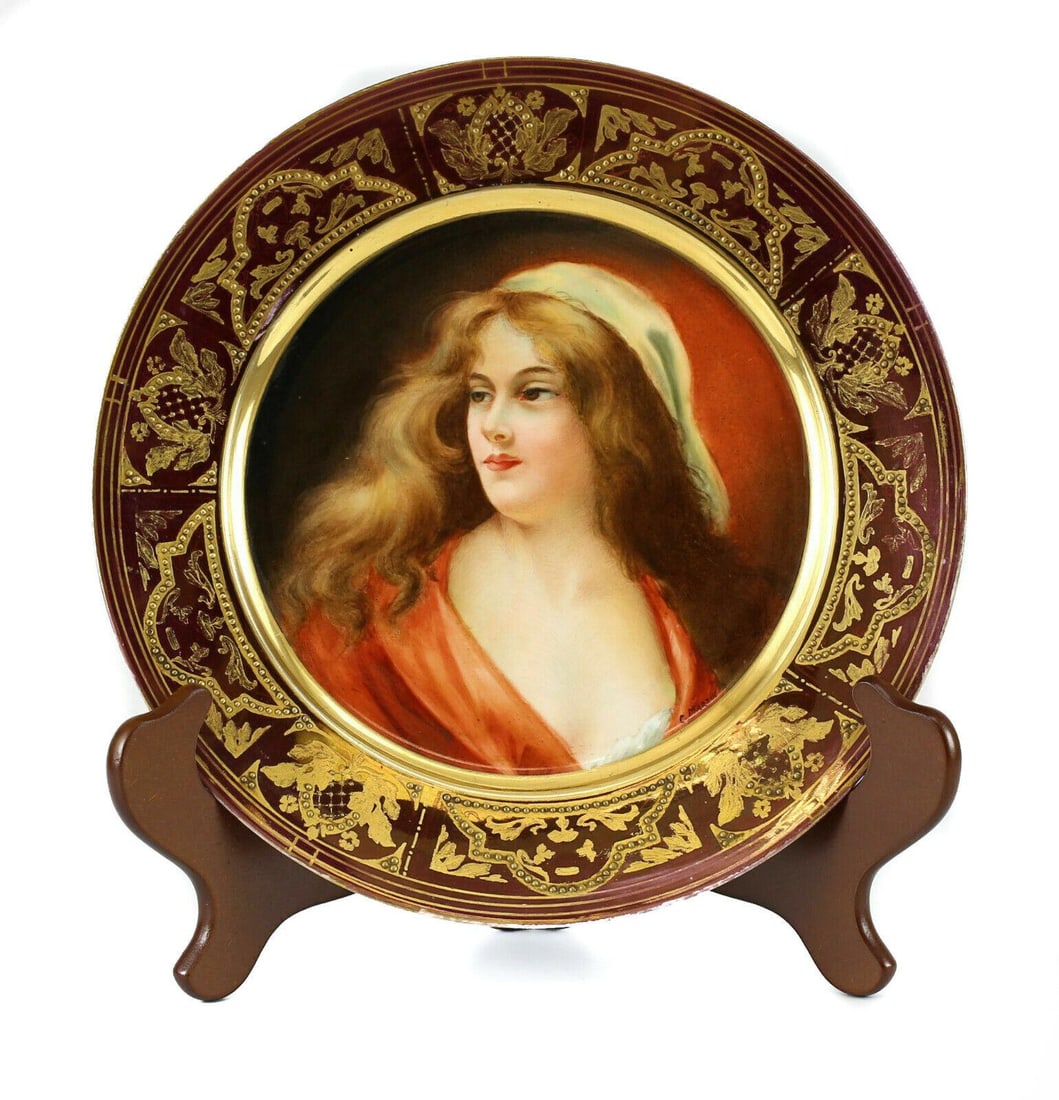 Royal Vienna Porcelain Portrait Plate c1900: Royal Vienna porcelain plate, signed; Generated the detail of the golden enamel. Beautiful Hand Painted Women in Red White & With Auburn Flowing Hair & the Tight Hint of a Smile. Mark Makers on the ba