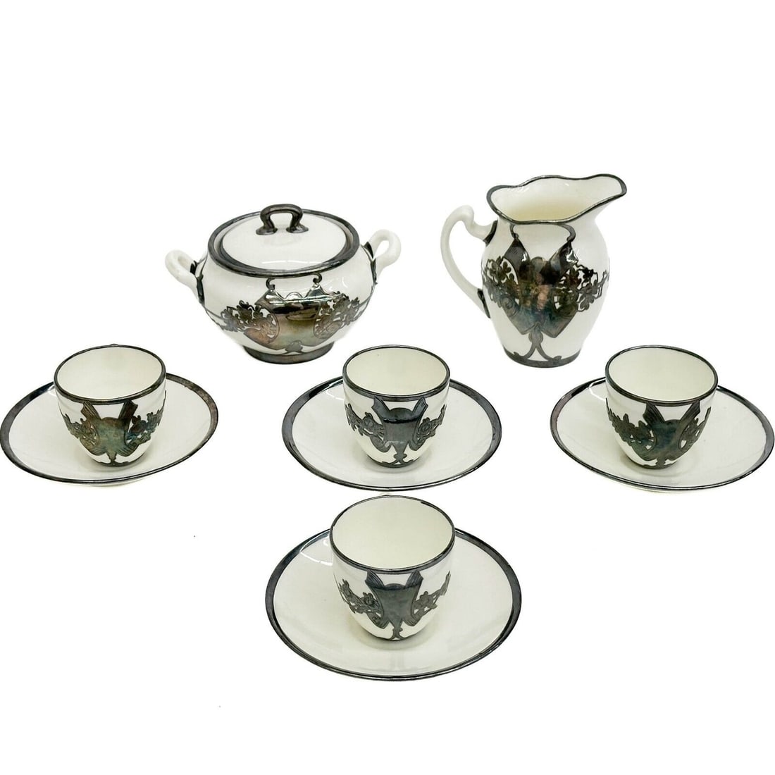 6pc Mauser English Silver Mounted Porcelain Cream Sugar Demitasse Cup & Saucers: Mauser English Silver Mounted Porcelain Cream Sugar Demitasse Cup & Saucers, circa 1890. Set includes creamer, lidded sugar bowl, and 4 demitasse cup and saucers. Underside of saucers with Mauser mark