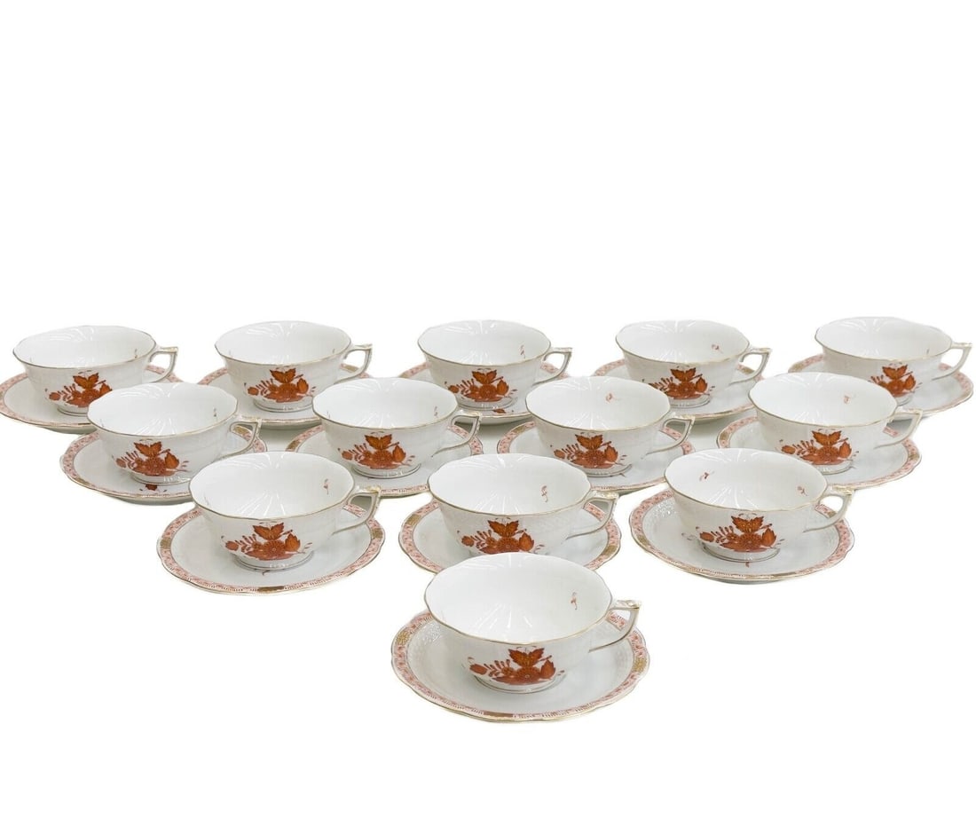 13 Herend Hungary Hand Painted Porcelain Cup & Saucers Chinese Bouquet Rust Red: 13 Herend Hungary Hand Painted Porcelain Cup & Saucers Chinese Bouquet Rust. Decorated with rust-colored flowers with gilt accents, a textured basketweave edge. Underside marked Herend with impressed