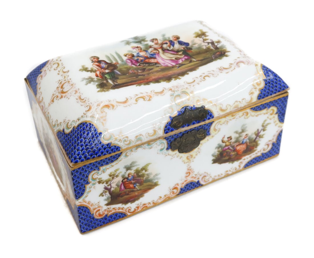 German Hand Painted Porcelain Dresser Box, Blue Scale Courting Scenes, Late 19 C: German hand painted porcelain dresser box, Late 19th Century. Blue scale edges with various courting scenes to exterior and lid. Gilt steel hinges. Weight: Approx. 2 lb Measurements: Approx. 7.125 inc