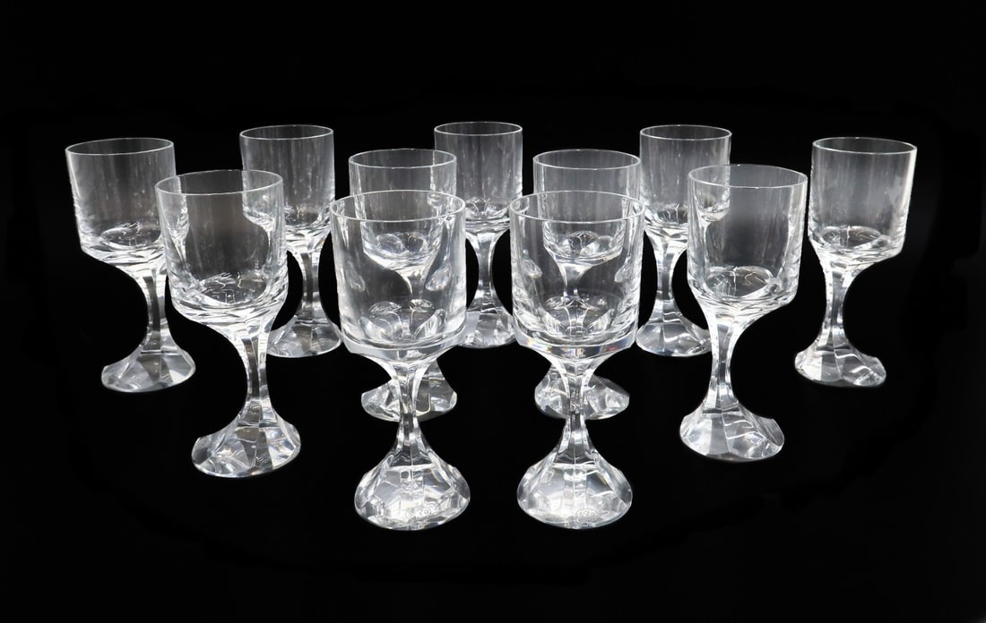 11 Baccarat France Crystal Glass White Wine Goblets in Narcisse: 11 Baccarat France crystal glass white wine goblets in Narcisse. Modernist off center bowed stem. Acid etched baccarat mark to underside. Weight: Approx. 12 lbs Measurements: Approx. 2.325 inches diam