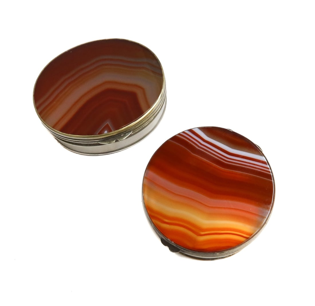 Pair Silvered Metal Banded Agate Round and Oval Trinket Boxes 20th Century: Pair Silvered metal banded agate round and oval trinket boxes 20th Century. Banded agate stones to lids. Weight: Approx. 0.5 lbs Measurements: Approx.Round Box: 2 inches diameter x 0.75 inches Conditi