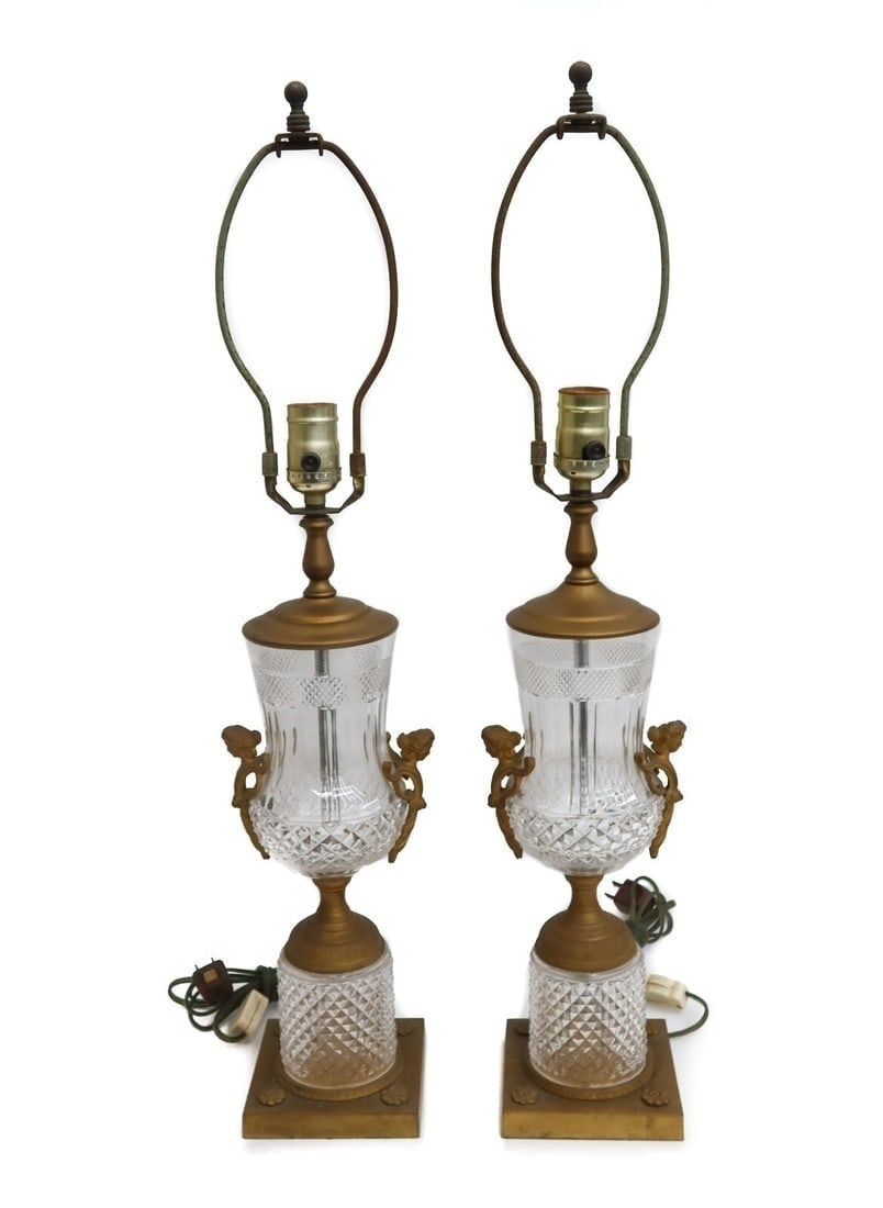 Pair French Gilt Bronze and Cut Glass Lamps Early 20th Century Figural Heads: Pair French gilt bronze and cut glass lamps, Early 20th Century. Cut glass diamonds to glass with figural heads to handles. Engraved roses to base. Weight: Approx. 10 lbs Measurements: Approx. 4.75 in