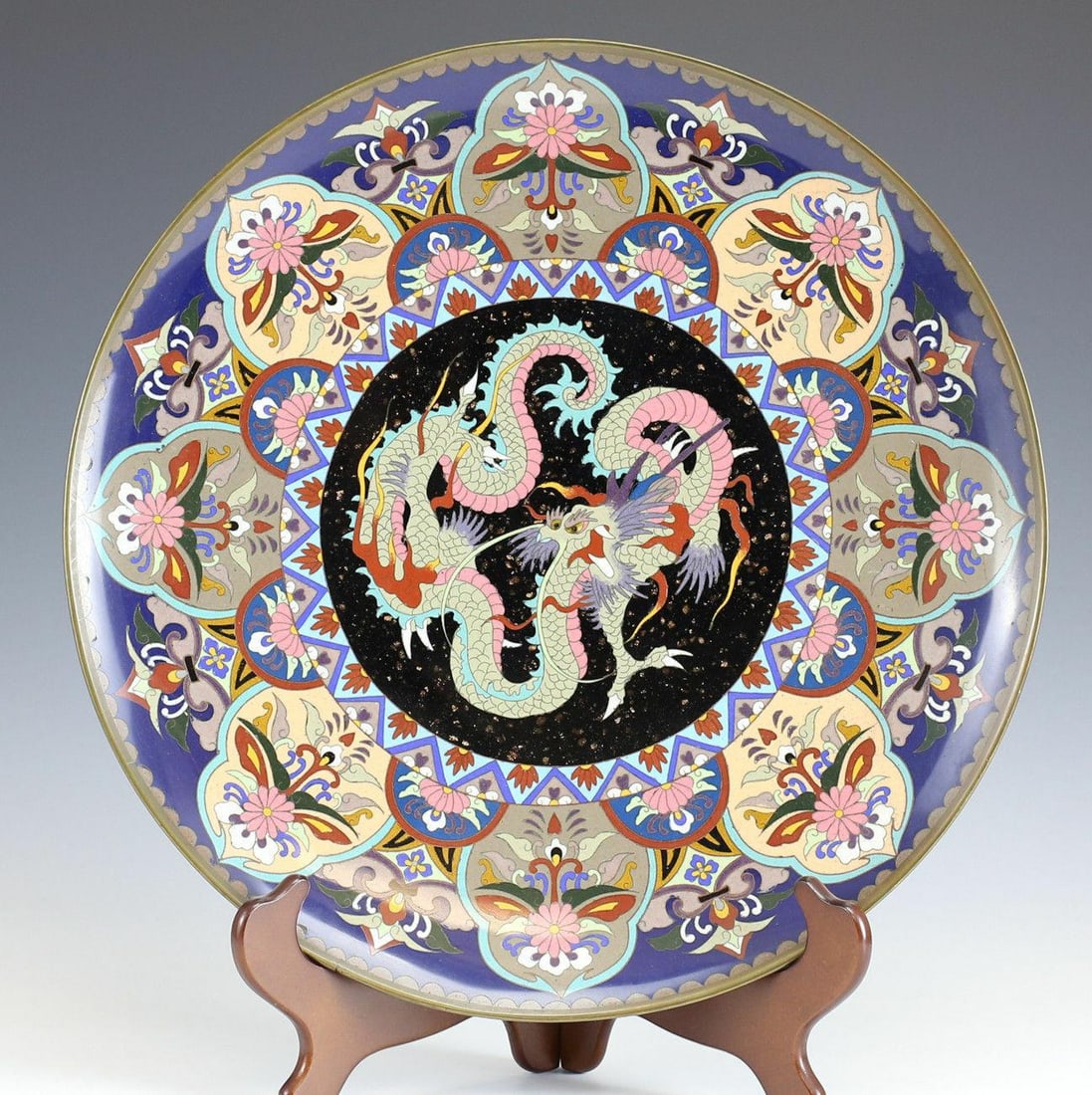 Japanese Cloisonne Platter, Features 3 Toed Dragon Tatsu Goldstone Flecks. c1900: Large Japanese cloisonne charger / platter - Central design features 3-toed dragon (tatsu), surrounded by stylized florals - goldstone flecks, circa 1900. Two holes in footing to allow for hanging. Me
