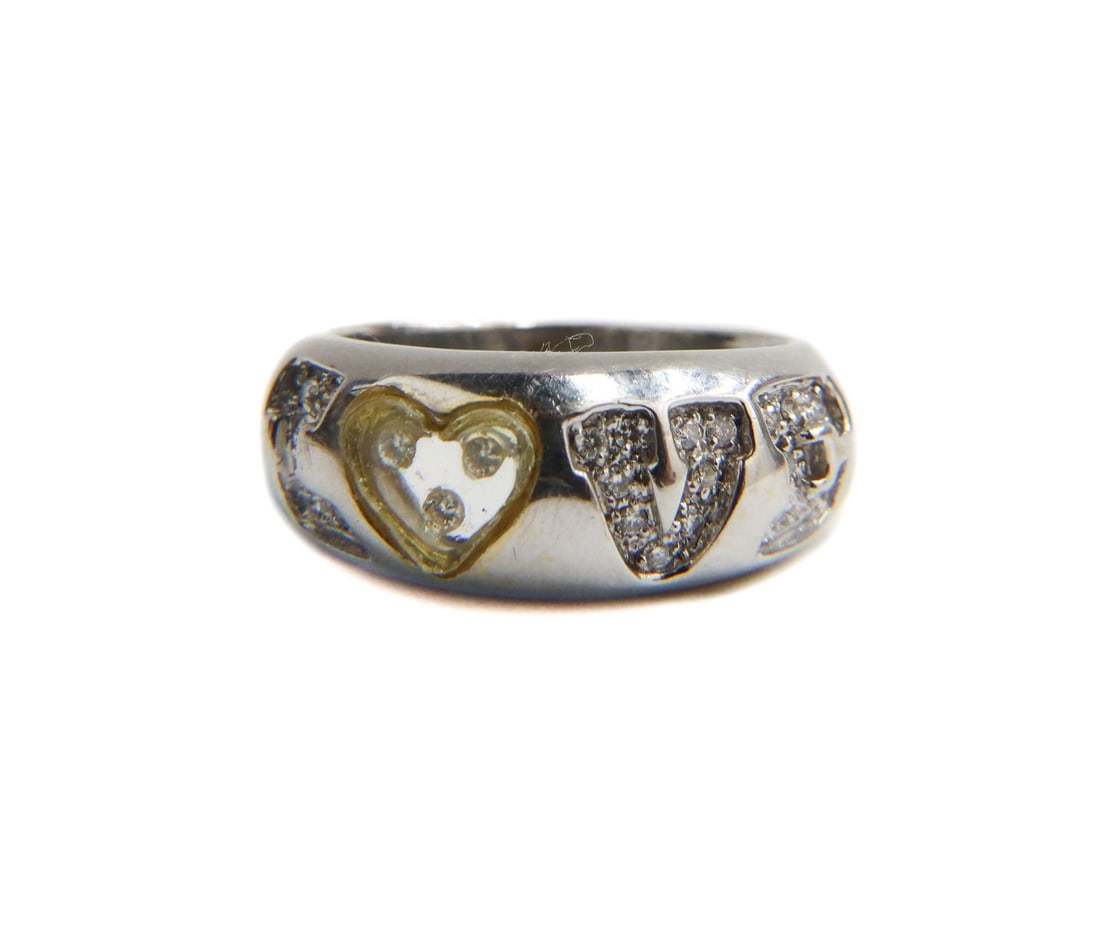 18k White Gold and Diamond LOVE Ring Size 6.5: 18k white gold and diamond LOVE ring Size 6.5. Embedded diamonds forming the word "LOVE" with a lucite acrylic heart to the "O". The diamonds weighing approximately 0.37 carats total. Marked 18k. Weig