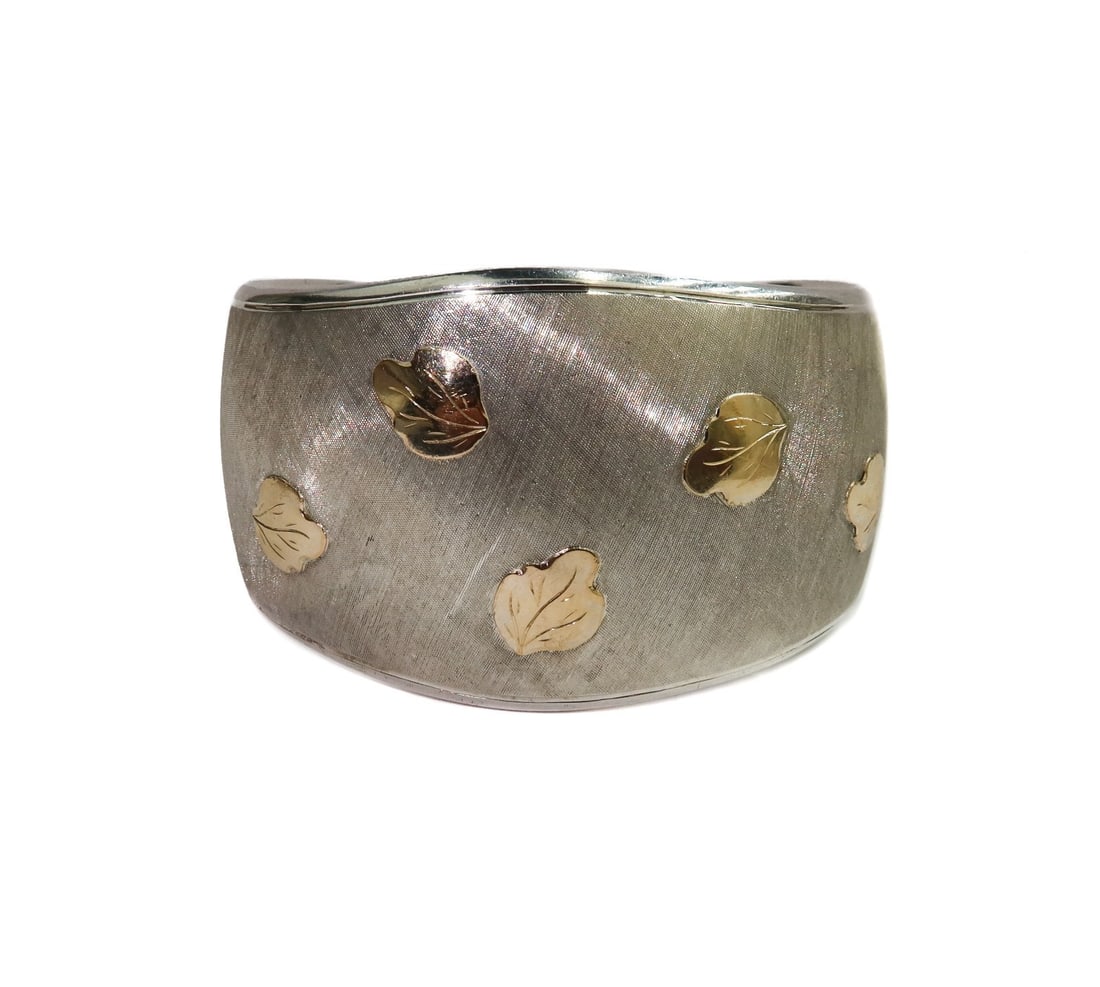 18k Yellow Gold and Sterling Silver 925 Leaf Cuff Bracelet: 18k Yellow Gold and Sterling Silver 925 Leaf Cuff Bracelet. Brushed textured silver with applied gold leaves throughout. Marked 925 and 750 to inner band. Weight: Approx. 36.26 grams Measurements: App