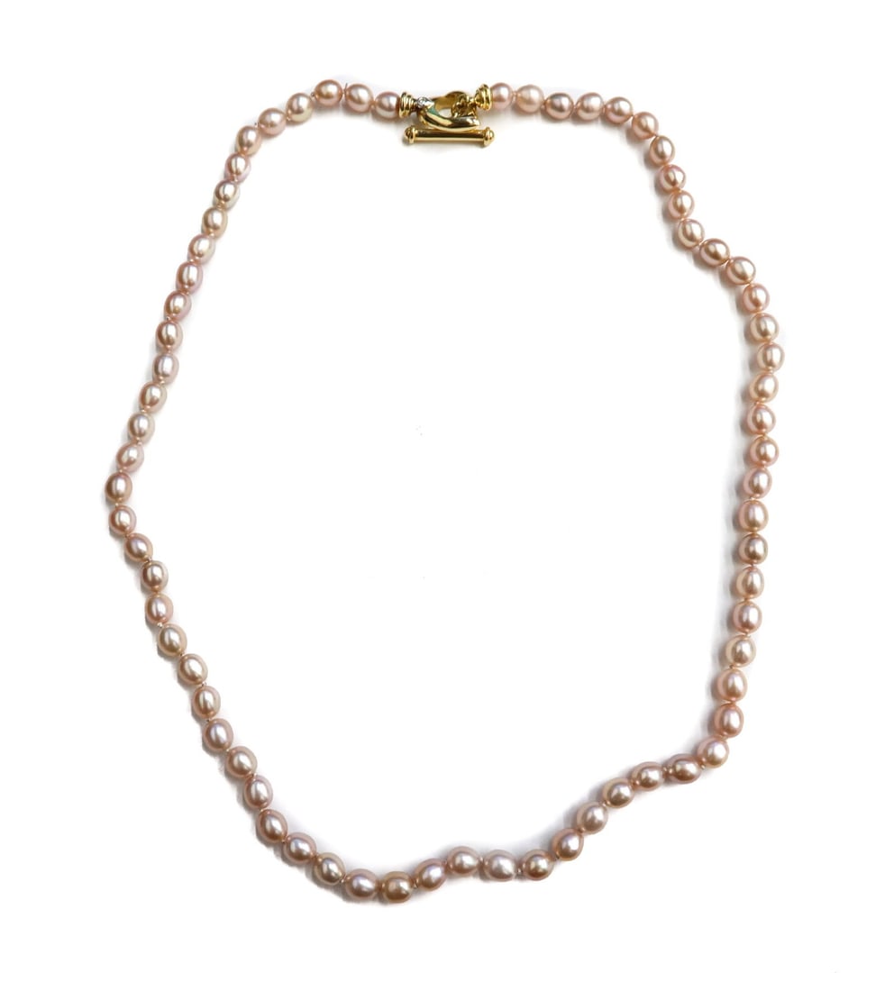 18k Yellow Gold and Oval Pink Cultured Pearl Toggle Heart Clasp Necklace: 18k Yellow Gold and Oval Pink Cultured Pearl Toggle Heart Clasp Necklace. Oval cultured pearls measuring approximately 5.3mm x 4.6mm. Heart toggle clasp with a round cut diamond to that weighs approxi