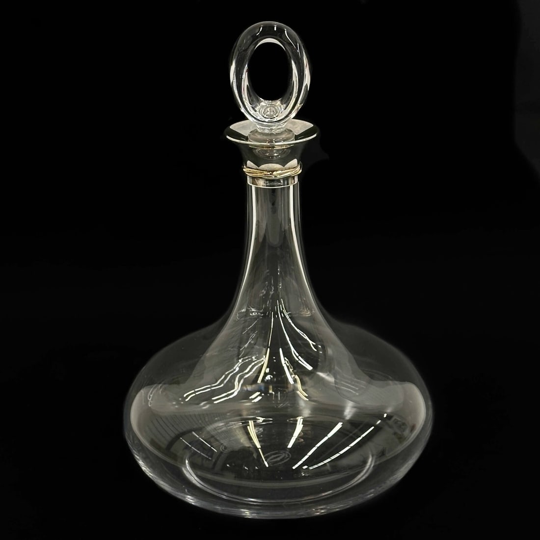 Cartier Sterling Silver Mounted Glass Decanter in Trinity with Box: Cartier Sterling Silver Mounted Glass Decanter in Trinity. Glass decanter and stopper, silver mounts to decanter with band of gilt silver decoration. Cartier sterling marks to mounts. With original fi