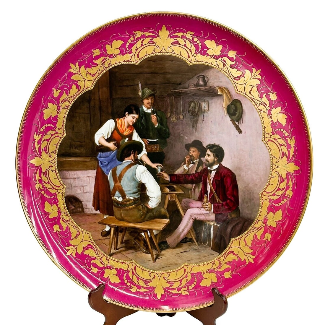 Royal Vienna Hand Painted Porcelain Charger Scene with Figures Signed c 1900: Royal Vienna hand Painted Porcelain Wall Charger, circa 1900. A red ground to the edge with gilt decoration, hand painted scene to the center depicting figures at a table. Artist signed Dressd. pins t