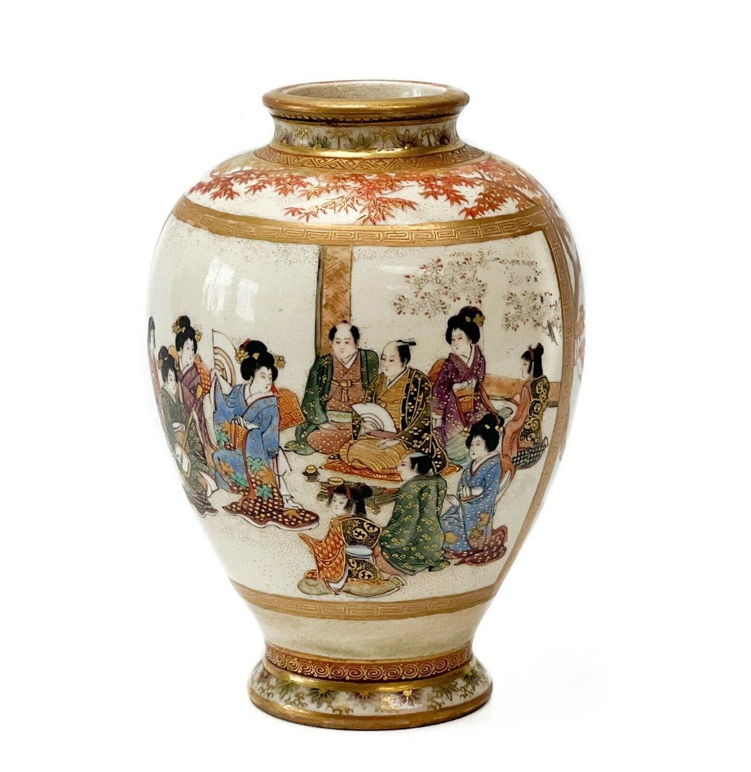 Japanese Kozan Satsuma Vase: Japanese Satsuma hand painted miniature porcelain vase, Meiji period. An off-white ground with hand painted images of a gathering of figures in traditional kimono underneath trees, and a panel depicti