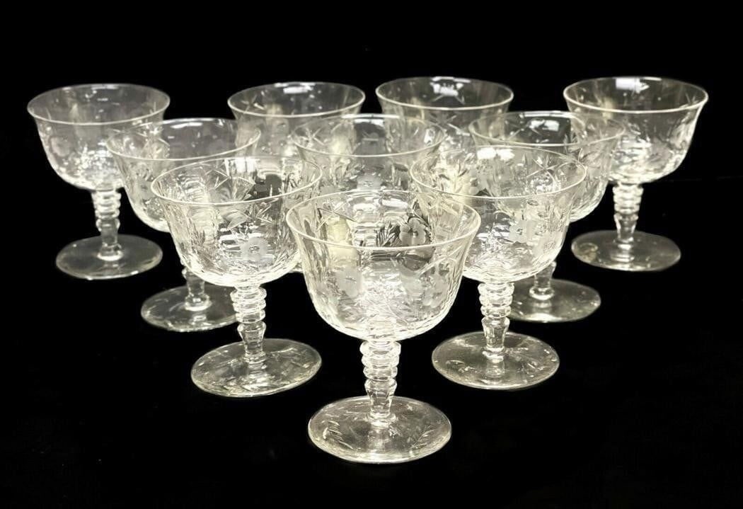 10 Cut Glass Wine Goblets Florals and Leaves: 10 etched cut glass wine goblets. Acid etched flowers and leave throughout the exterior of the goblets with a ridged stem. Weight: Approx. 6 lbs Measurements: Approx. 3.5 inches diameter x 4.25 inches