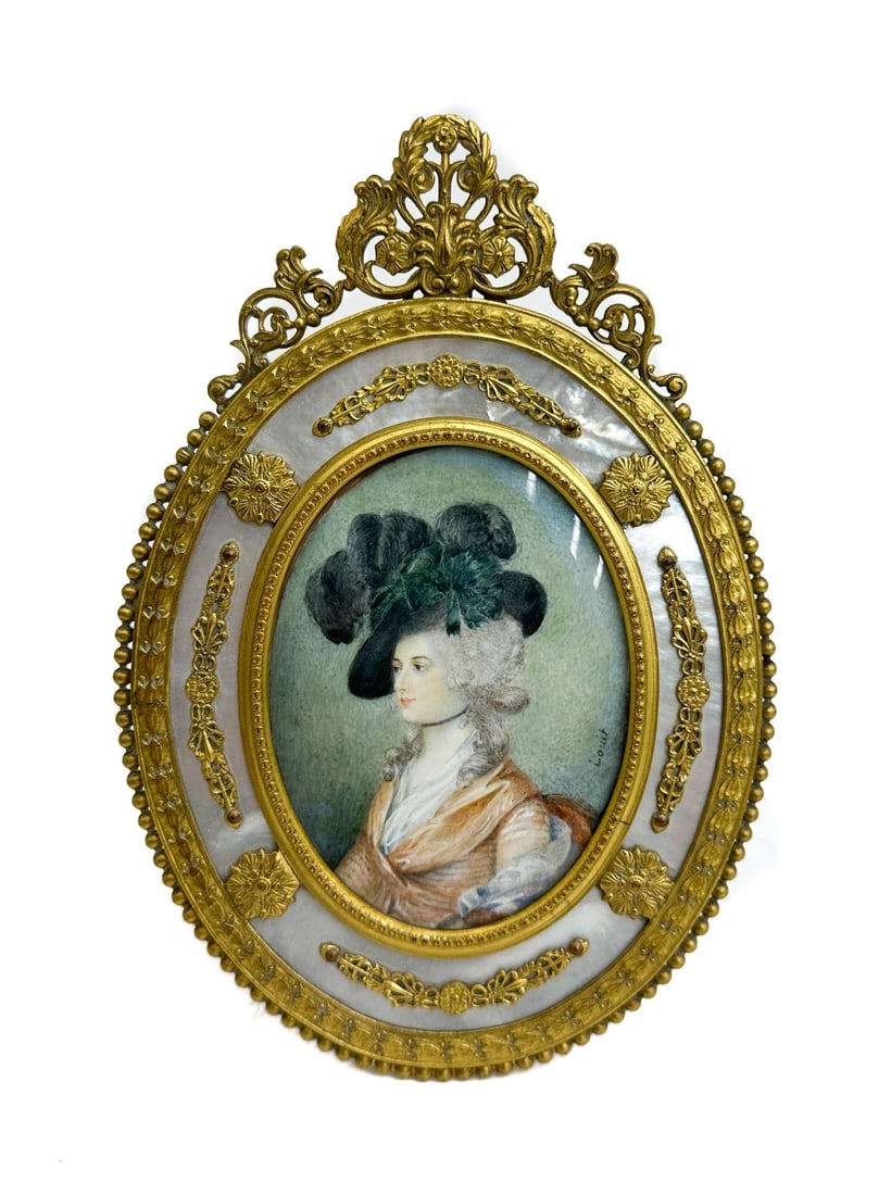 Continental Hand Painted Gouache on Celluloid Portrait of a Woman MOP Frame: Continental hand painted gouache on celluloid portrait of a woman, circa 1900. The portrait depicts a beauty in period era garbs. Artist signed "Louit" to edge. Framed in a gilt metal foliate leaves a