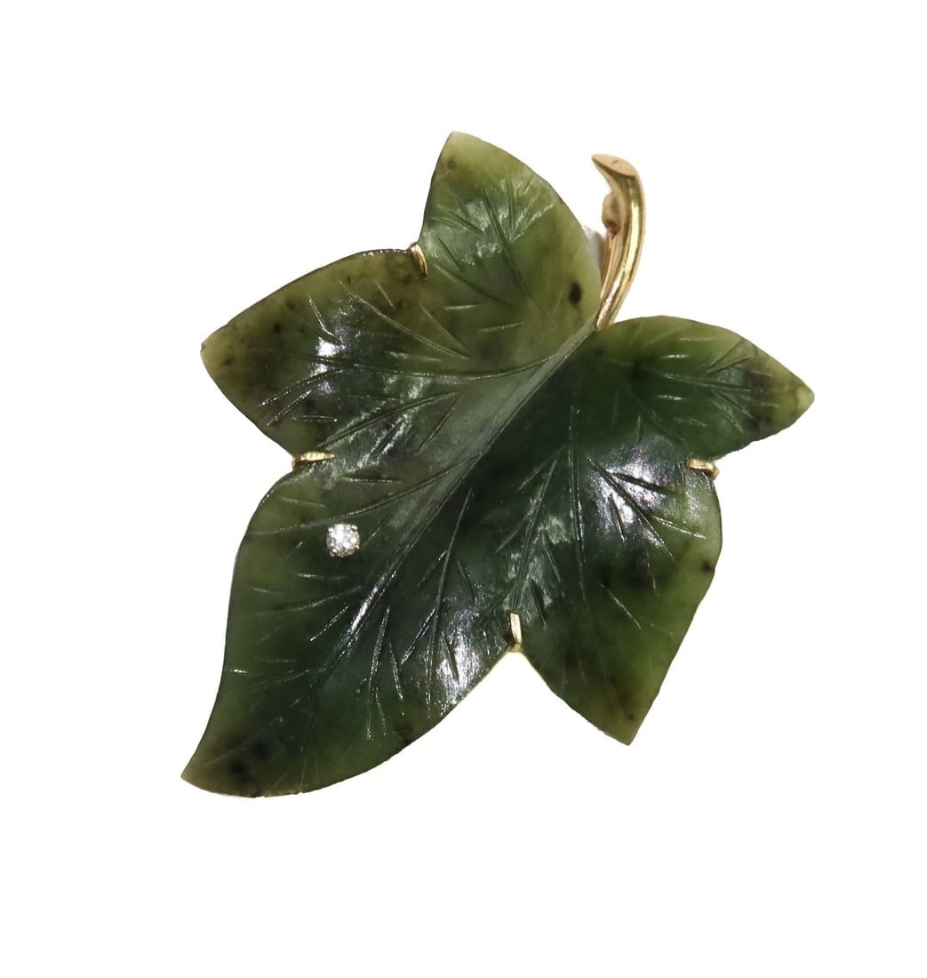 14k Yellow Gold Spinach Jade and Whtie Sapphire Leaf Brooch: 14k Yellow Gold Spinach Jade and Whtie Sapphire Leaf Brooch. One round cut white sapphire jewel to leaf measuring approx., 2.4mm. Marked 14k to back Weight Approx., 10.81 grams Measures Approx., 2.25 
