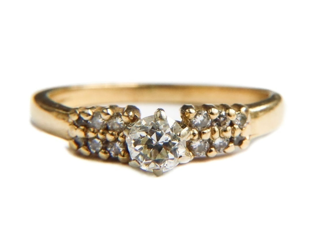 14k Yellow Gold and Diamond Ring, Size 7: 14k Yellow Gold and Diamond Ring, Size 7. Round cut diamond center measuring approximately 4.5mm diameter x 3.2mm and weighing roughly 0.41 carats. 12 brilliant round cut diamonds to band weighing app