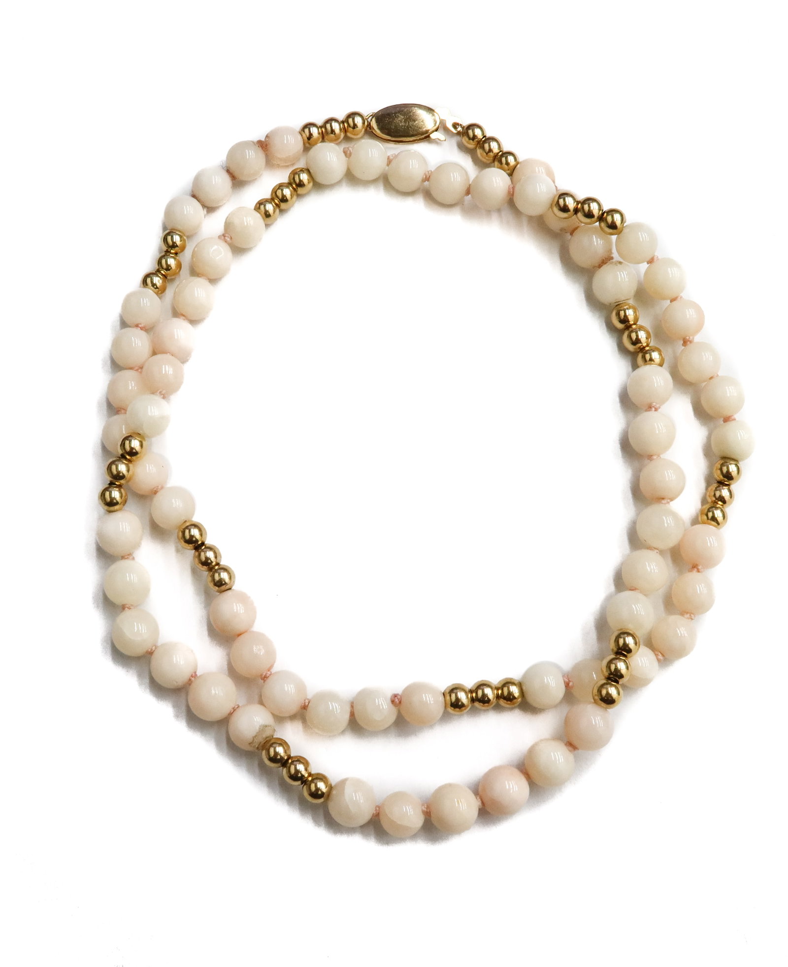 14k Yellow Gold and Pink Coral Beaded Necklace: 14k Yellow Gold and Pink Coral Beaded Necklace. Coral beads measuring approximately 6.07mm. Gold spacers measuring 3.85mm. Marked 14k to clasp. Weight Approx., 21.06 grams Measures Approx., 20.5 inche