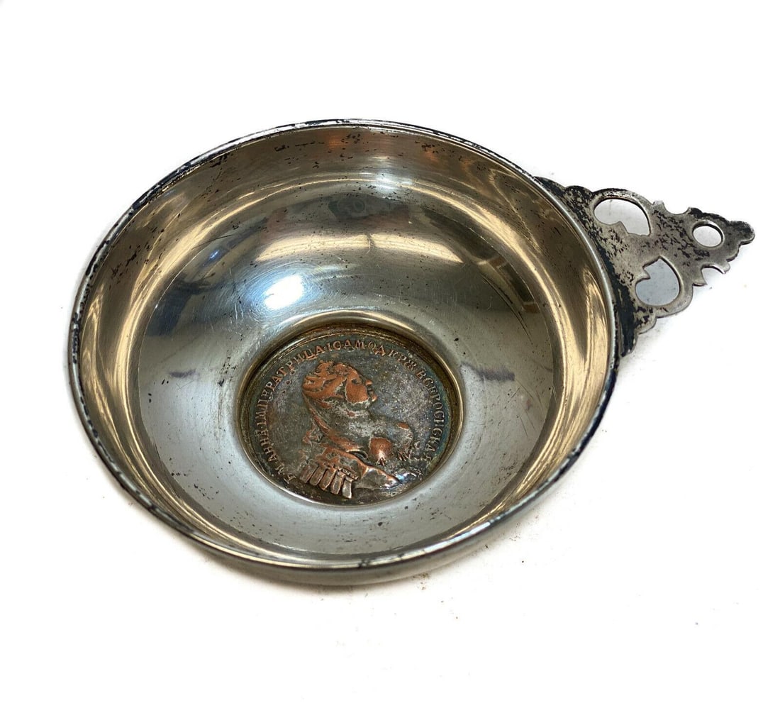 Sterling Silver and Greek Coin Mounted Inset Tastevin: Sterling Silver and Greek coin mounted inset tastevin. Sterling silver mark to the rim of the base. Weight: Approx. 1.73 ozt Measurements: Approx. 4.1 inches x 3 inches x 1 inch Condition: Very good c