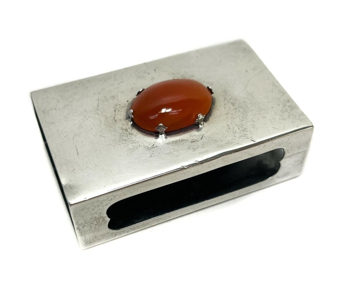 Yamanaka Sterling Silver & Carnelian Stone Match Box Holder #04519: Yamanaka sterling silver match book holder #04519. An applied cabochon carnelian stone to the center. Yamanaka mark to the edge. Weight: Approx. 1.02 ozt Measurements: Approx. 2.5 inches x 1.5 inches 