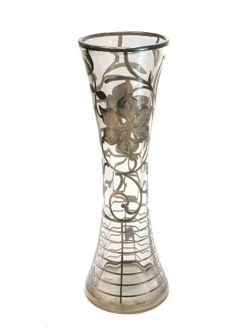 American Silver Overlay Clear Glass Vase, Mid Century. Florals & Stripes: American silver overlay clear glass vase, Mid Century. Florals to the center with striped accents. Weight: Approx. 1 lbs Measurements: 3.5 inches x 10.5 inches tall Condition: Very good condition. Lig