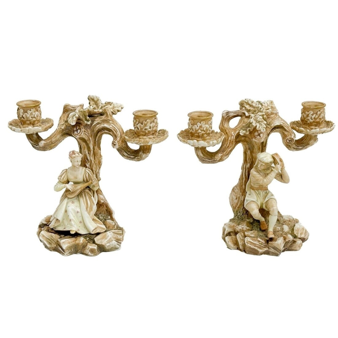 Pair Royal Worcester Porcelain Blush Ivory Candelabras Figures Musicians 1885: Pair Royal Worcester Porcelain Blush Ivory Candelabras, 1885. Tree form double candle holders each with figures to the base. One depicts a man with a tambourine, the other with a woman with a mandolin