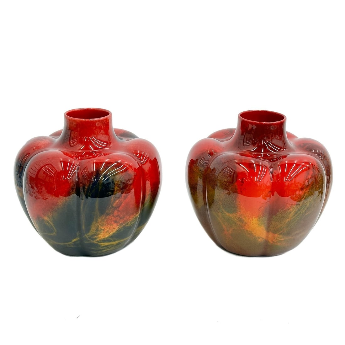 Pair Royal Doulton Porcelain Sung Ware Noke Flambe Squat Form Vases c 1930: Pair Royal Doulton Porcelain Sung Ware Noke Flambe Squat Form Vases, circa 1930. Lobed panels with vibrant purple, yellow, green, and blue abstract colors to the bright red base. Royal Doulton mark to