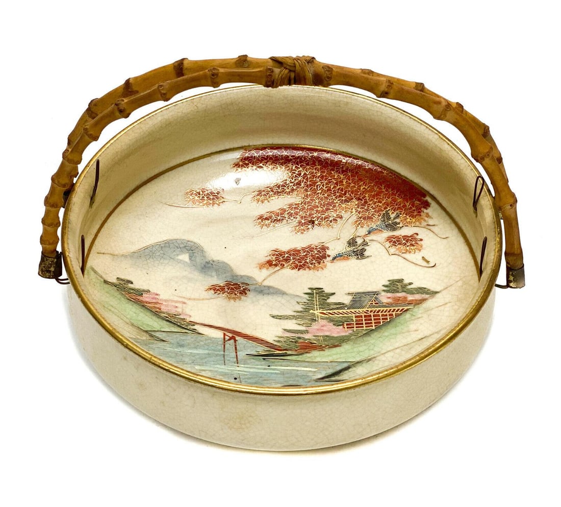 Japanese Satsuma Hand Painted Porcelain Handled Bowl: Japanese Satsuma hand painted porcelain handled bowl. Beautiful hand painted Japanese maple leaves with a village landscape scene to the background. Wooden handle. Japanese CPO marks to the underside.