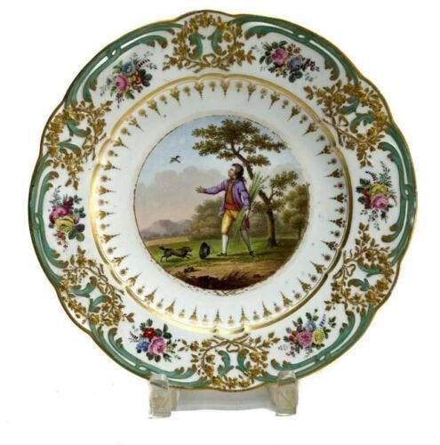 Sevres France Hard Paste Porcelain Cabinet Plate, 18th Century. Genre Scene: Sevres France hard paste porcelain cabinet plate, 18th Century. The central area with a hand painted genre scene of a man holding barley. Scallop rimmed with molded relief flowers and ribbons. Sevres 
