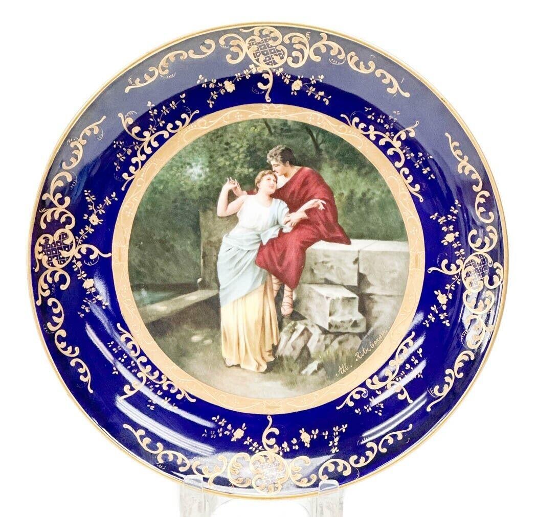 Royal Vienna Hand Painted Porcelain Charger Courting Scene Signed c. 1920: Royal Vienna Hand Painted Porcelain Charger, circa 1920. A cobalt blue ground to the edge with gilt decoration. Hand painted courting scene to the center. Artist signed All. Ritzberger. Underside with
