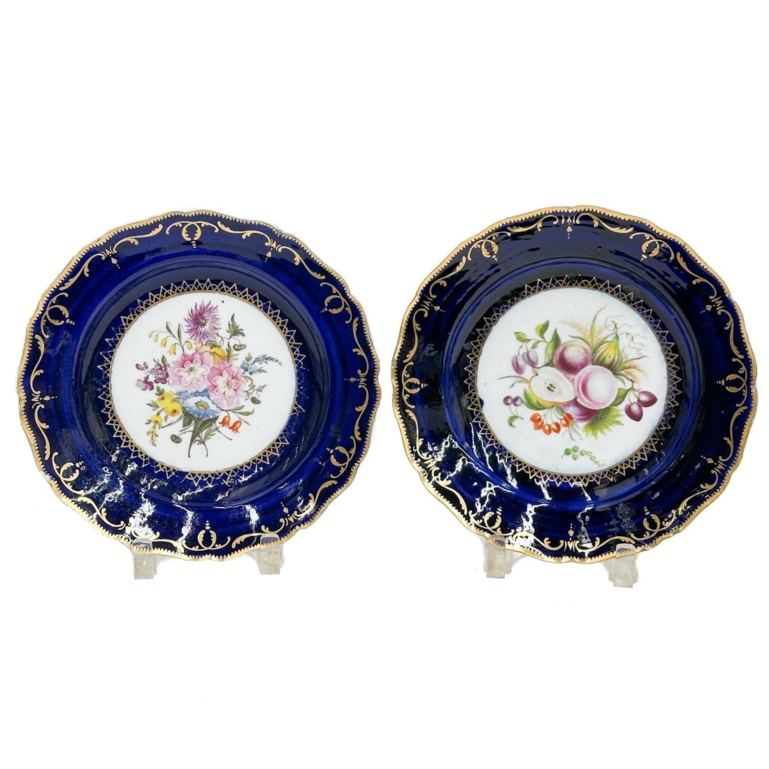 Pair Coalport English Hand Painted Porcelain Plates Fruits Florals c1820: Pair English Hand Painted Porcelain Plates circa 1820. A cobalt blue ground with gilt accents, hand painted floral bouquet to center of one, fruits to the other. Apparently unmarked, attributed to Coa