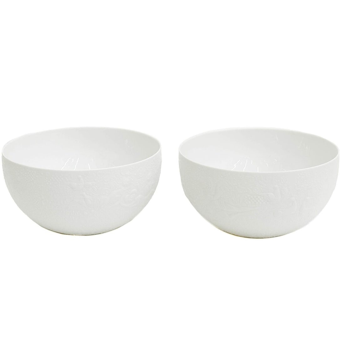Pair Rosenthal Germany Porcelain 8 inch Vegetable Bowls in Magic Flute White: Pair Rosenthal Germany Porcelain 8 inch Vegetable Bowls. White porcelain with embossed figures around the exterior with a matte finish. Underside marked Rosenthal Germany, Bijorn Wiinblad. Weight: App