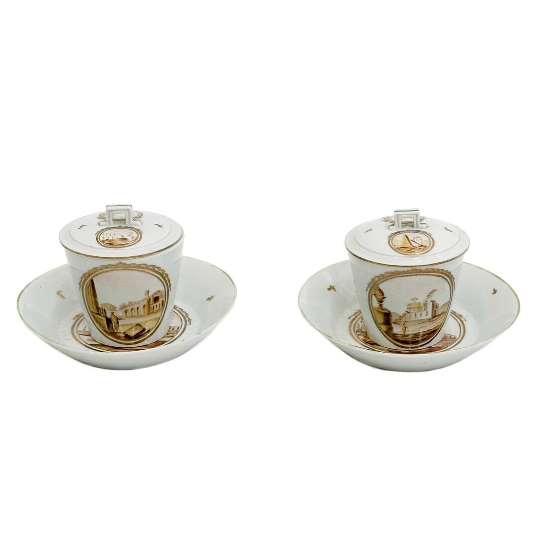 Pair Gotha Germany Hand Painted Porcelain Covered Cup & Saucers circa 1810: Pair Gotha Germany Hand Painted Porcelain covered cups & Saucers circa 1810. A white ground with sepia tone hand painted scenes featuring buildings and seaside images. Gilt accents, geometric shaped h