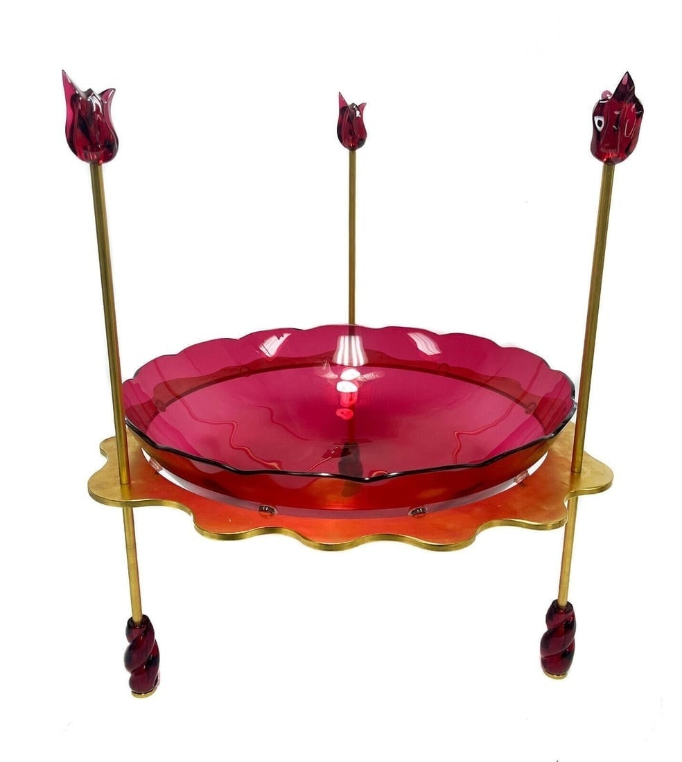 Baccarat Cranberry Art Glass and Bronze Centerpiece: Baccarat glass Enfer Rouge centerpiece bowl. Cranberry art glass to the scallop rimmed center bowl and rosette formed top and base finials. 3 legged gilt bronze wave form frame. Baccarat cache mark to