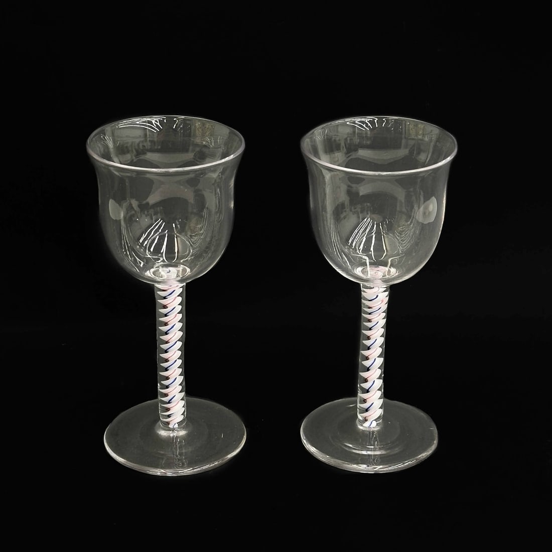 Pair English Air Twist Red White Blue Stem Wine Glasses 19th century: Pair English Air Twist Engraved Glasses, 19th century, possibly earlier. Red white and blue air twist stems. Polished pontil to the underside Weight: Approx. 1 lb Measurements: Approx. 2.25 inches dia