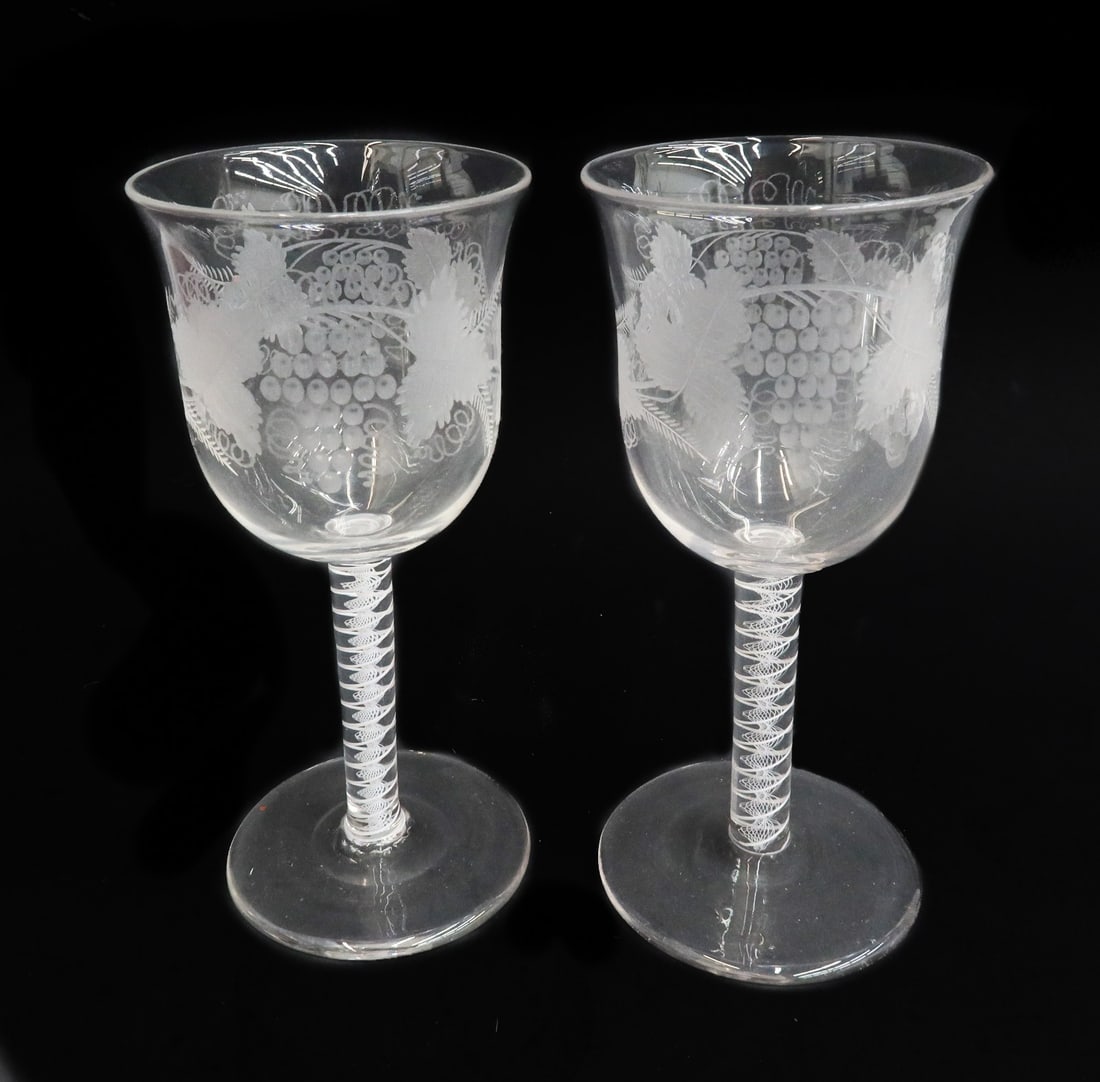 Pair English Georgian Air Twist Glass Wine Glass Goblets 19th Century or Earlier: Pair English Georgian Air Twist wine glass goblets likely 19th century or earlier. Etched grape leaves and vines. White lattice striped air twist decoration to the stem. With polished pontil. Weight: 