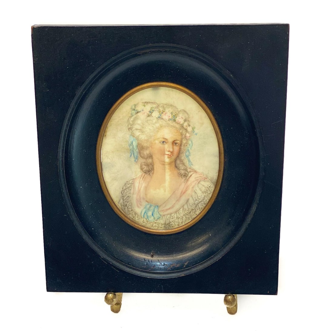 Continental Gouache & Watercolor Miniature Portrait of a Beauty, circa 1900: Continental gouache & watercolor miniature portrait of a beauty, circa 1900. The portrait depicts a distinguished beauty in lace garbs and wearing a floral crown. Framed in a black wood frame.