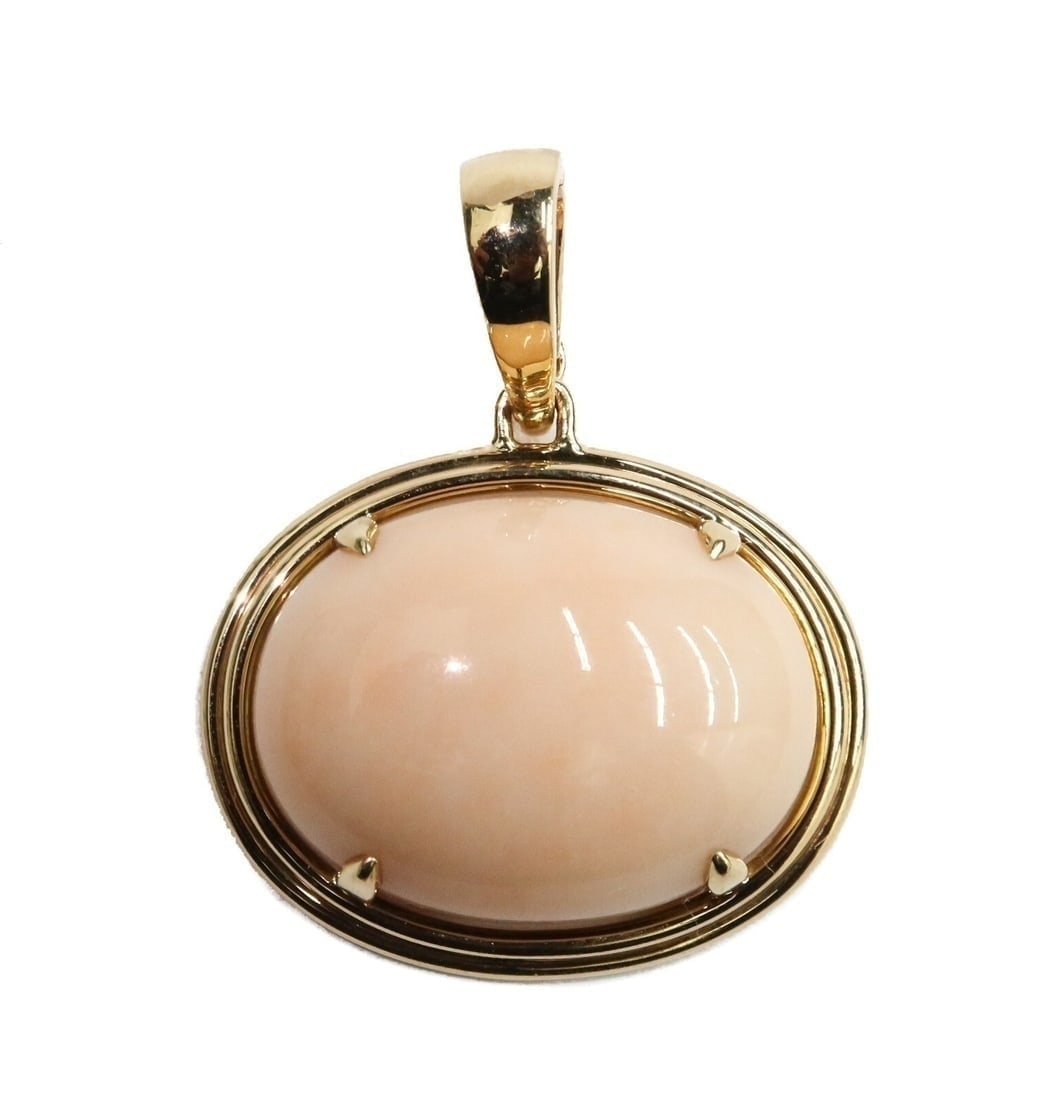 Gump's 14k Yellow Gold and Cabochon Coral Necklace Pendant: Gump's 14k yellow gold and cabochon coral necklace pendant. The cabochon coral measuring approximately 38mm x 20.5mm x 9.5mm. Marked Gump's to inner hook and Gump's 14k to edge of back rim Weight: App